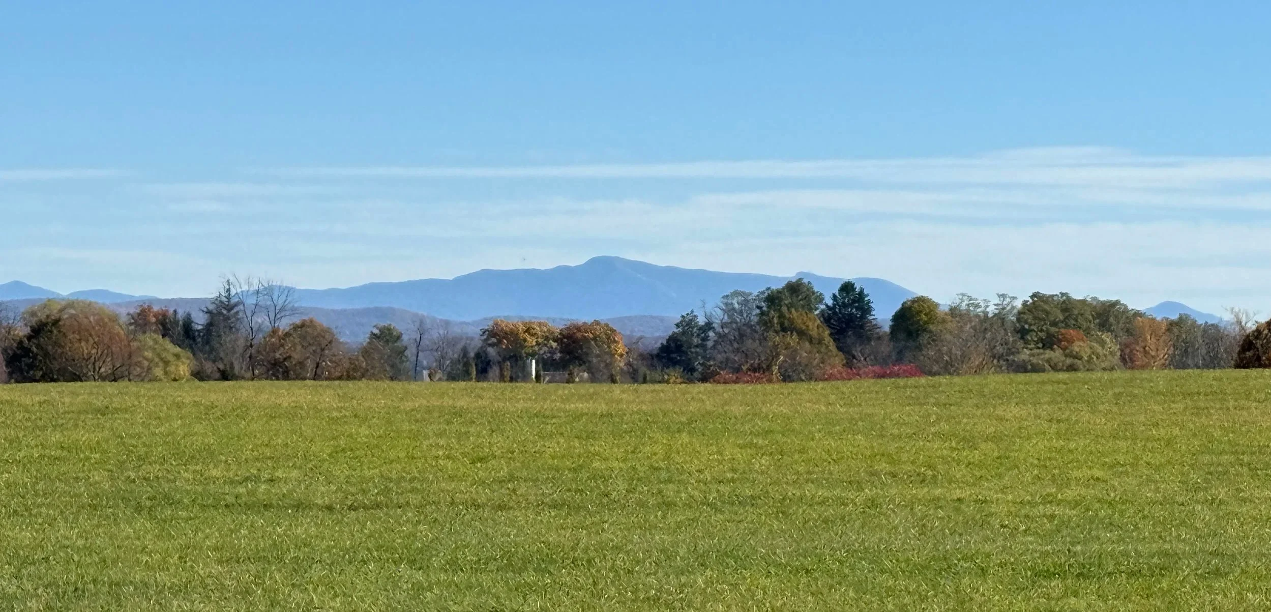 panoramic view of Kibbe Farm's north fields with Mount Mansfield in the background