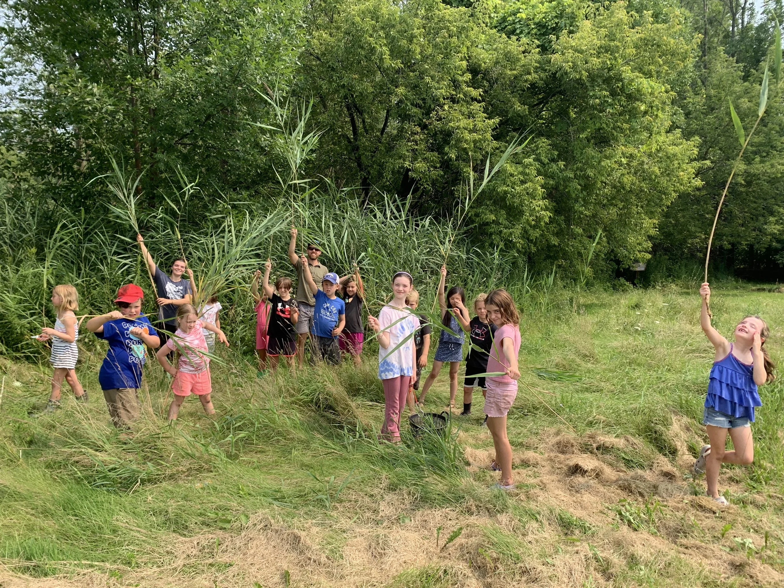 a large group of campers playing with reeds at the Rec Park