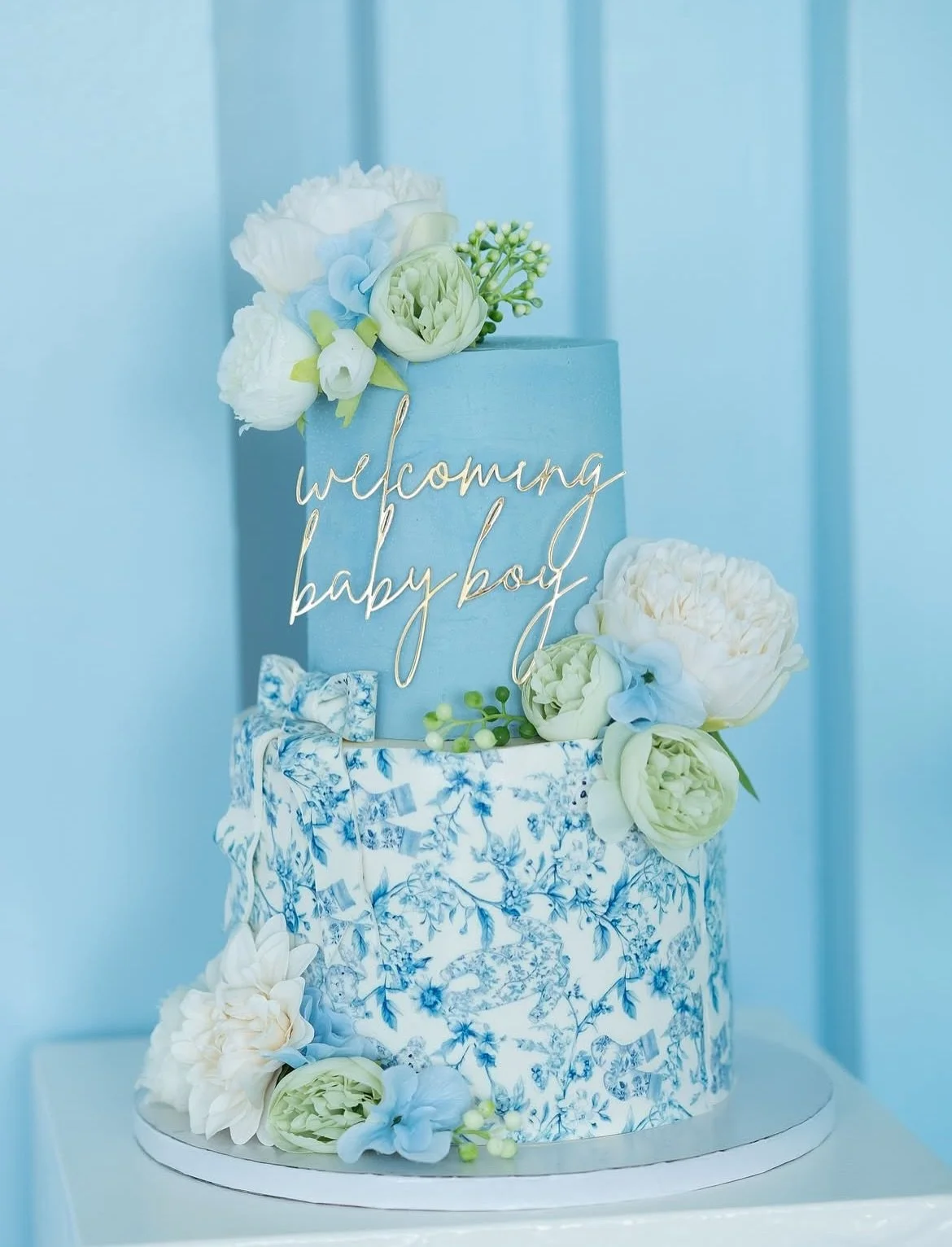 A Timeless Design for a Timeless Moment ✨
Elegant and refined, this two-tier baby shower cake features delicate florals and a gold topper&mdash;designed to make your celebration unforgettable. Inquire today for your custom creation.
.
.
.
#babyshower