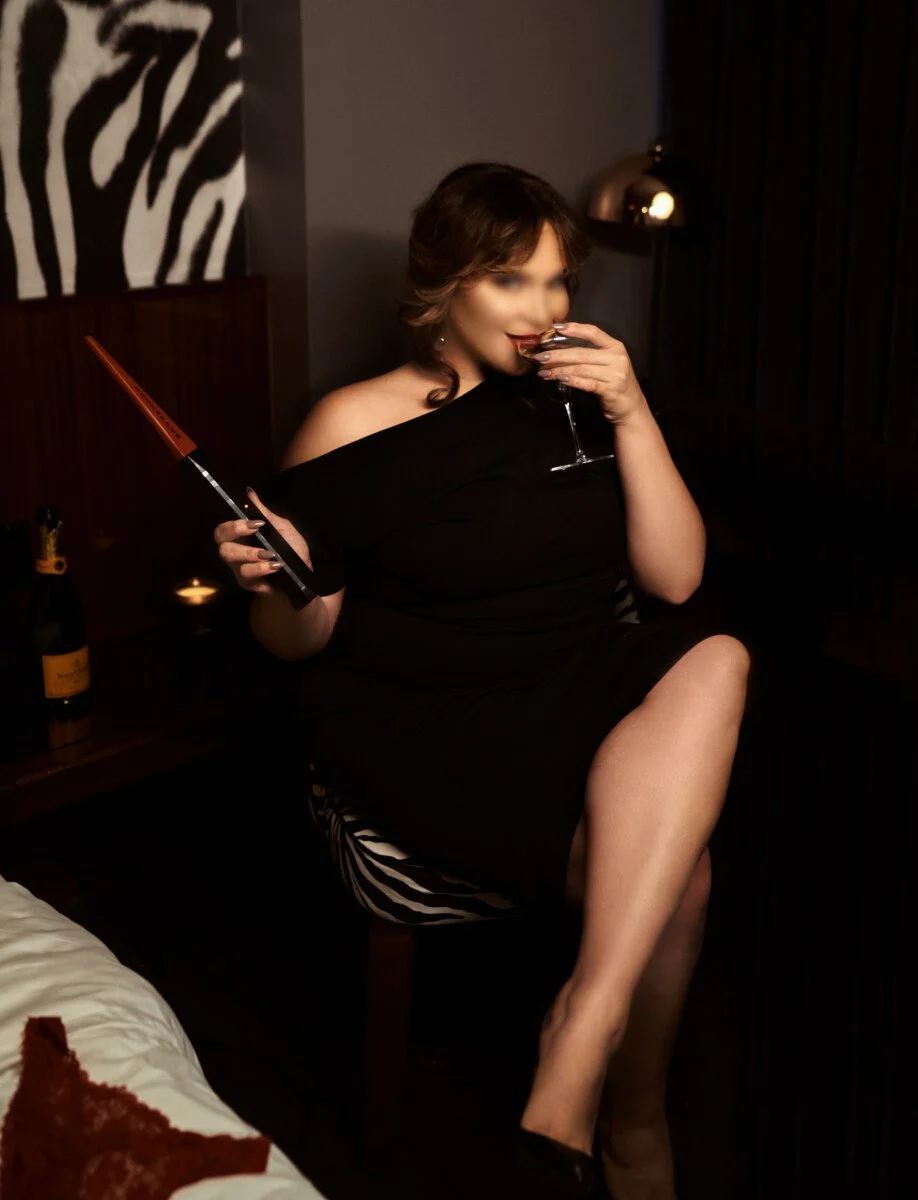 Powerful yet inviting presence of Zoey Belladonna, NYC Dominatrix, capturing the balance of dominance and gentle femdom.