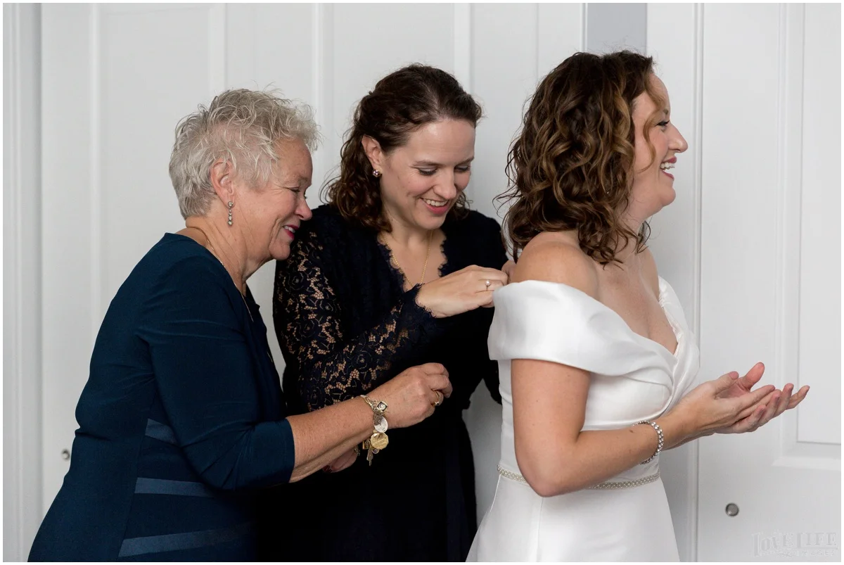 Anxo Cidery DC Wedding bride putting on dress.jpg