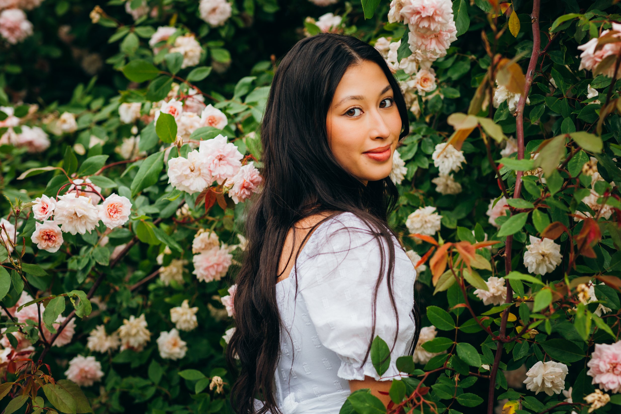 Long haired senior among roses