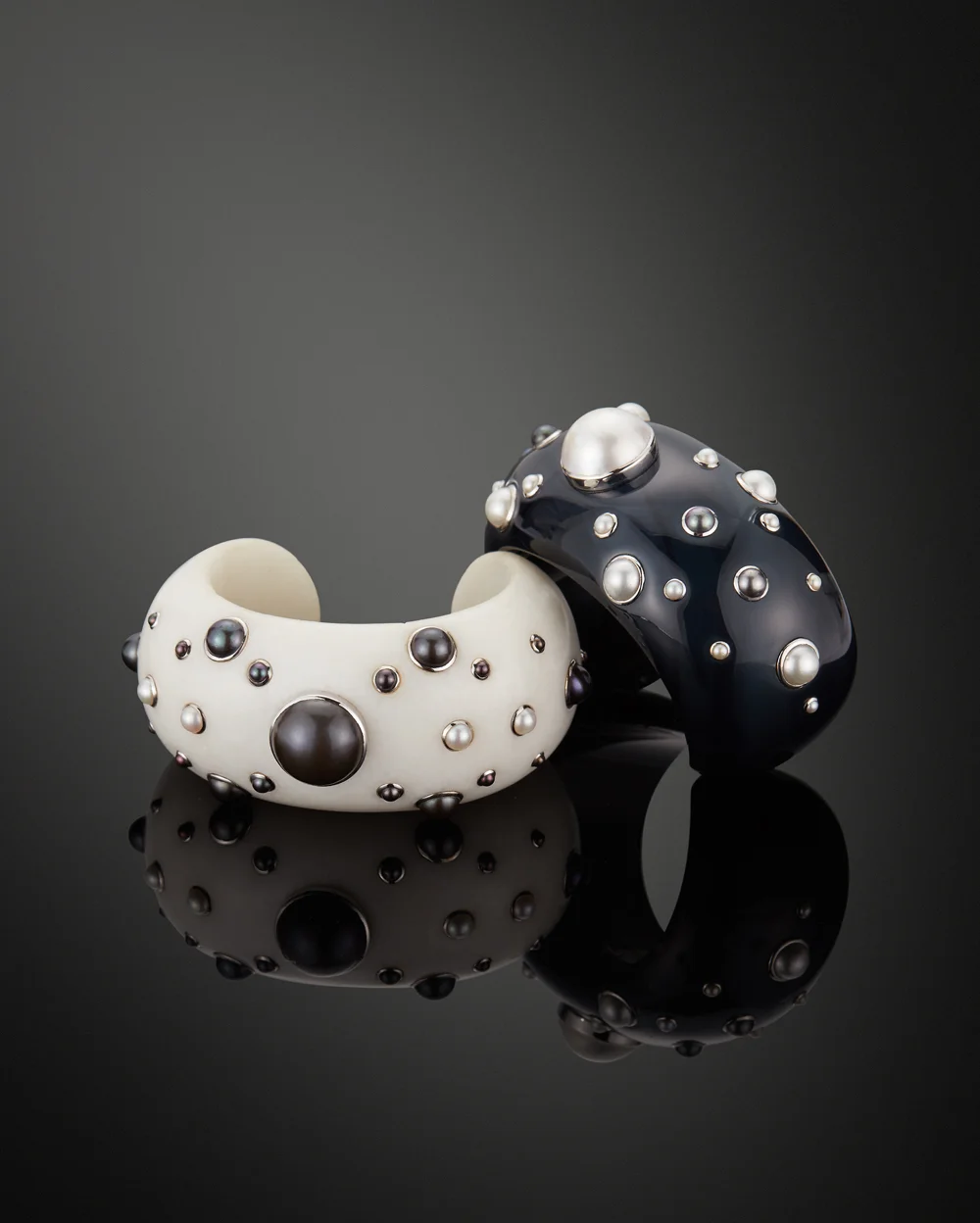 A pair of "Day" and "Night" Bangles. Blue Agate, Cacholong with cream & gray Pearls by Verdura