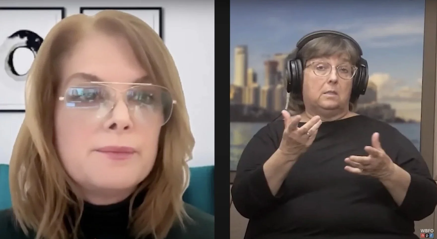 Maria Perrin, in a black turtleneck and clear aviator glasses is on the left, looking into the camera. On the right is a sign-language interpreter in black wearing large headphones.