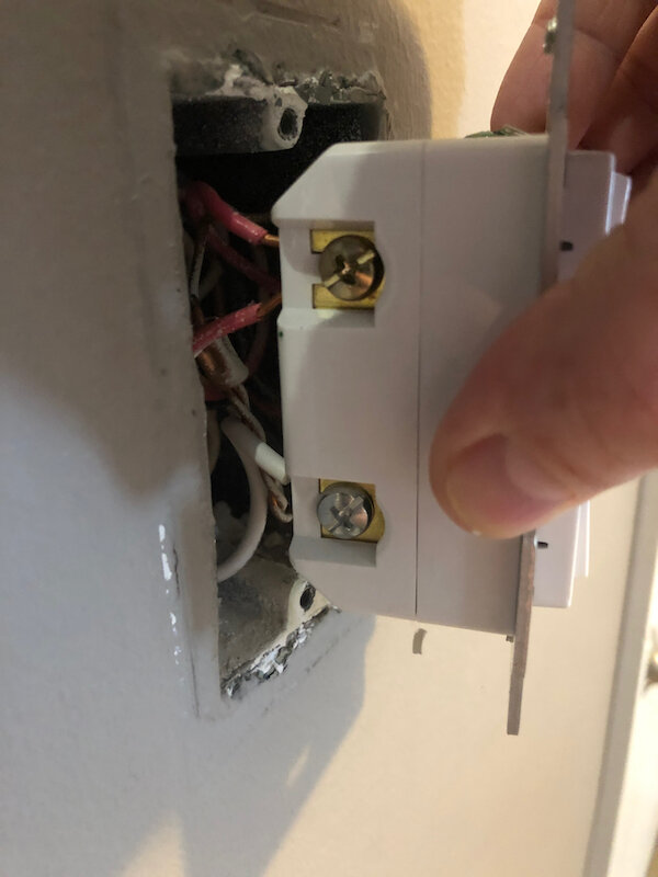 Wiring on one-side of a three-way smart switch. This switch has two red traveler wires connected, because it is in the middle of a chain of a five-way switch.