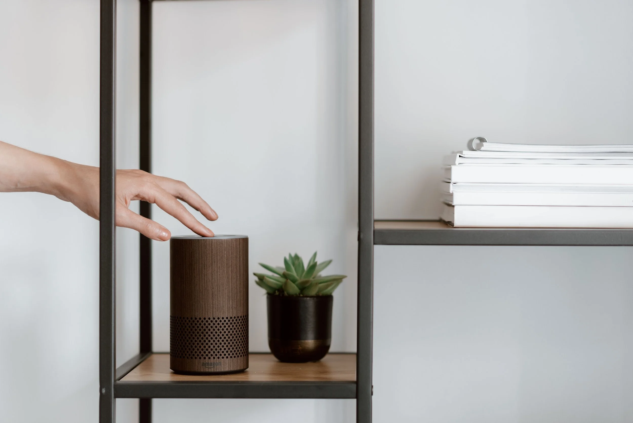 A smart speaker on a minimalist shelf