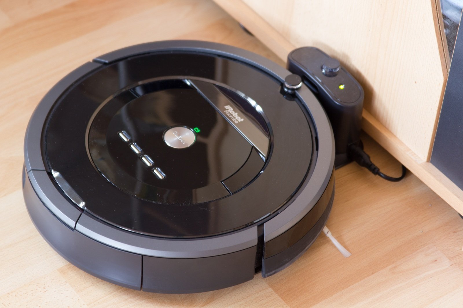 Older Roomba robot vacuum model on it's charging station