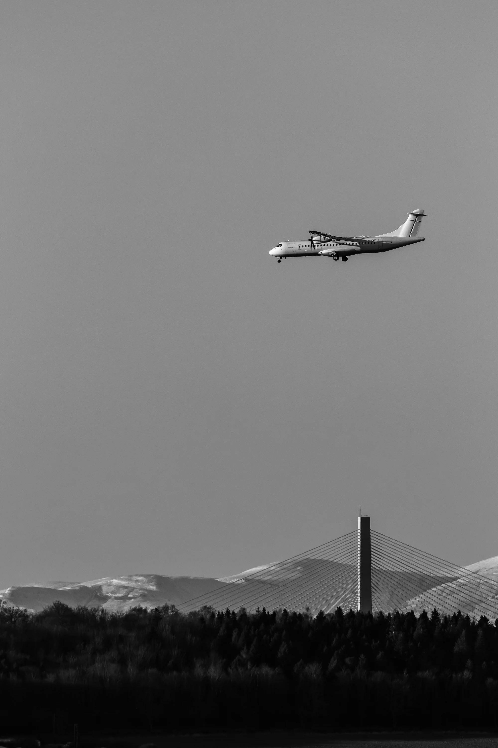 (1318) Twin Propeller Plane on Final Approach to Edinburgh Airport Flying Over the Queensferry Crossing and Ochil Hills in Background. January 2019 copy.jpg