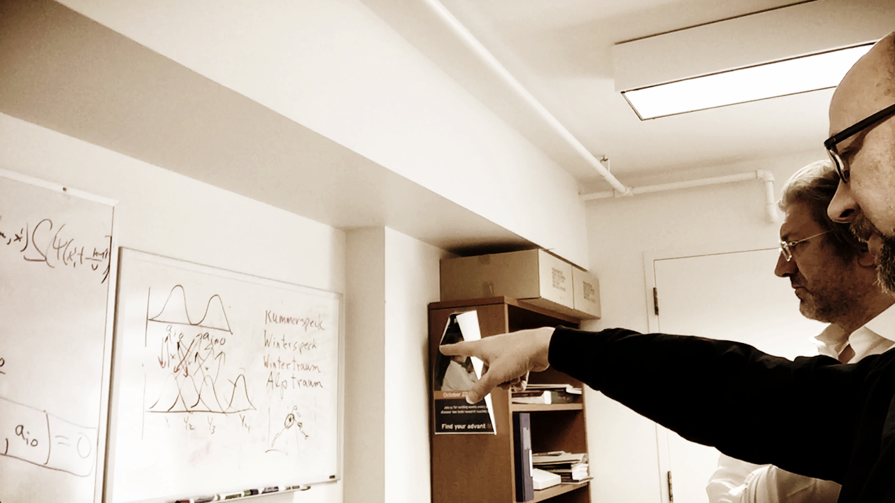 Dr. McIntosh points out to his whiteboard sketches as he and Dr. Viktor Jirsa jam during a brainstorming session.