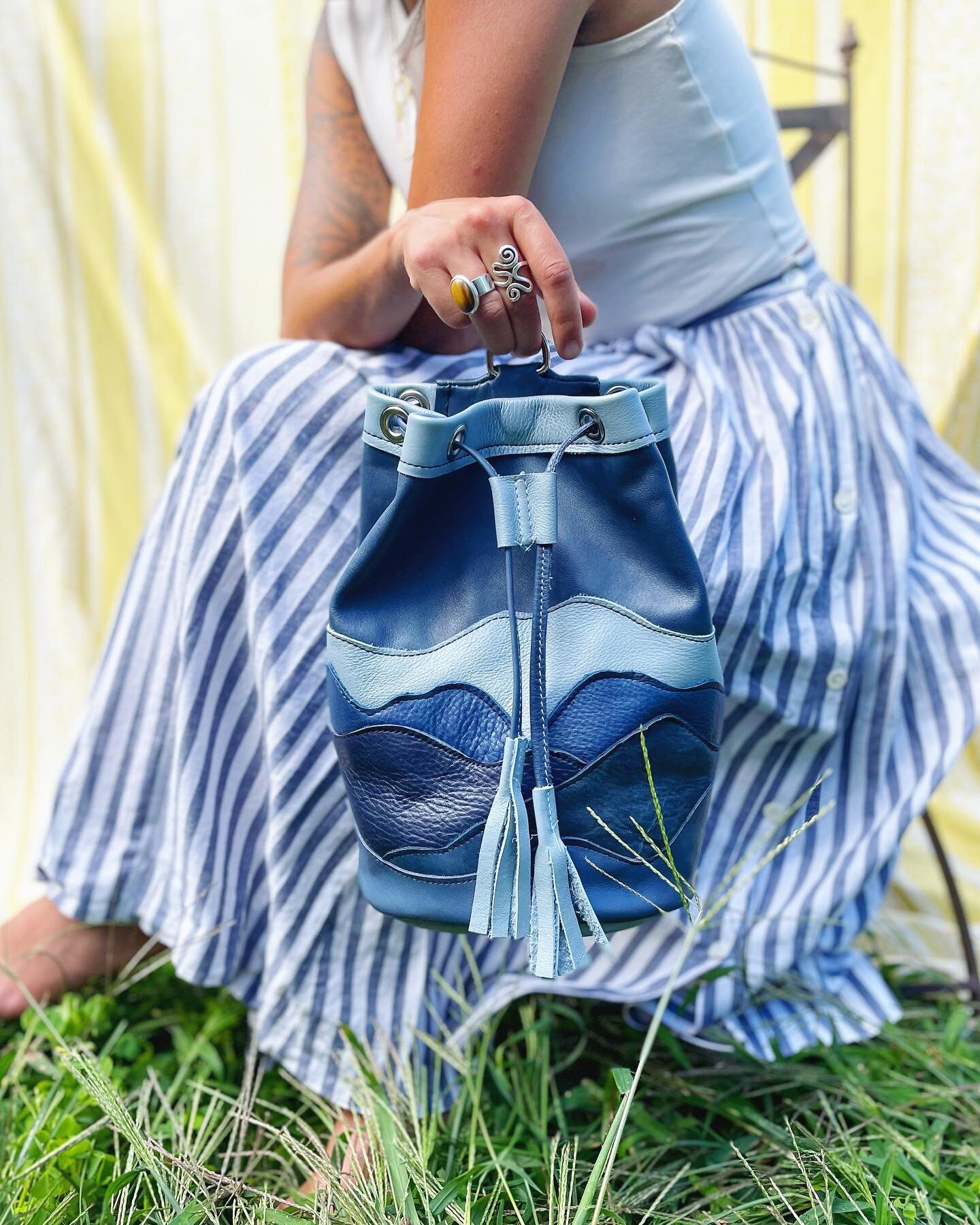 The Sweet Blue Layers of home ✨ now available in the shop 
&bull; 
Wear this bag as a crossbody, backpack or sling! 
&bull;
#bucketbag #mountains #mountainlover #art #wearableart #slowfashion #naturelover #leathersmith #leathercraft #shophandmade