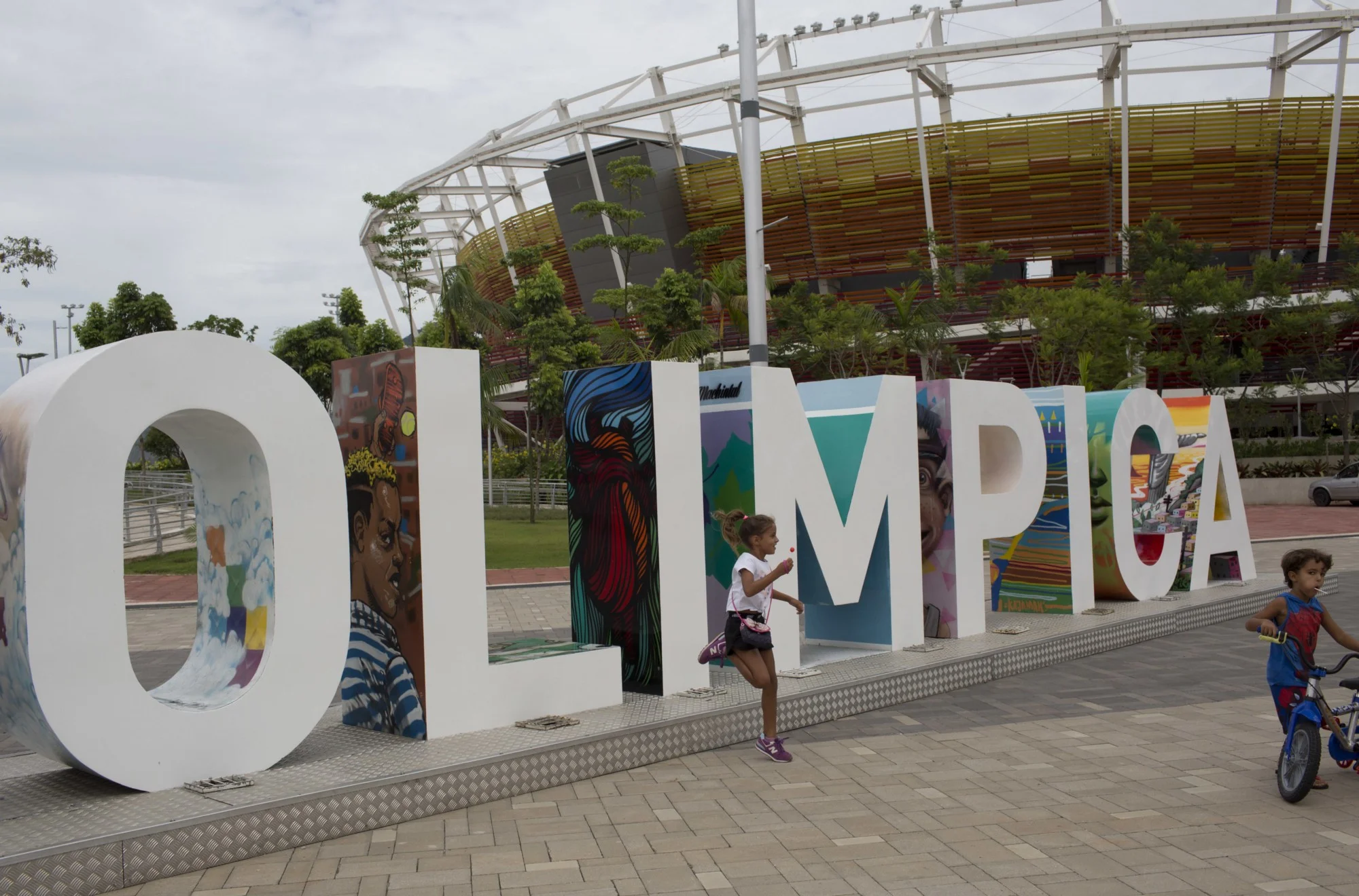 Some children use an Olympic monument as a playground | AP