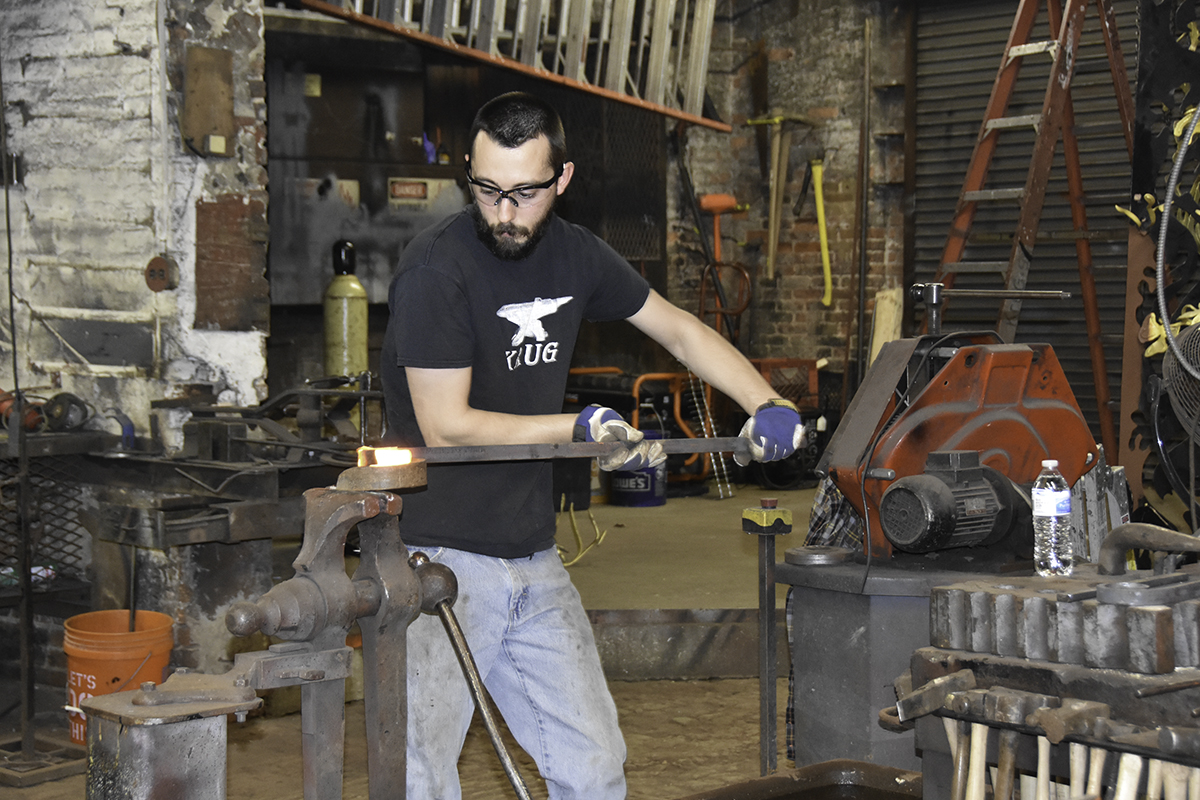 Blacksmith on hand at the G. Krug annual December open house demonstrate early and time-tested ironworking techniques.