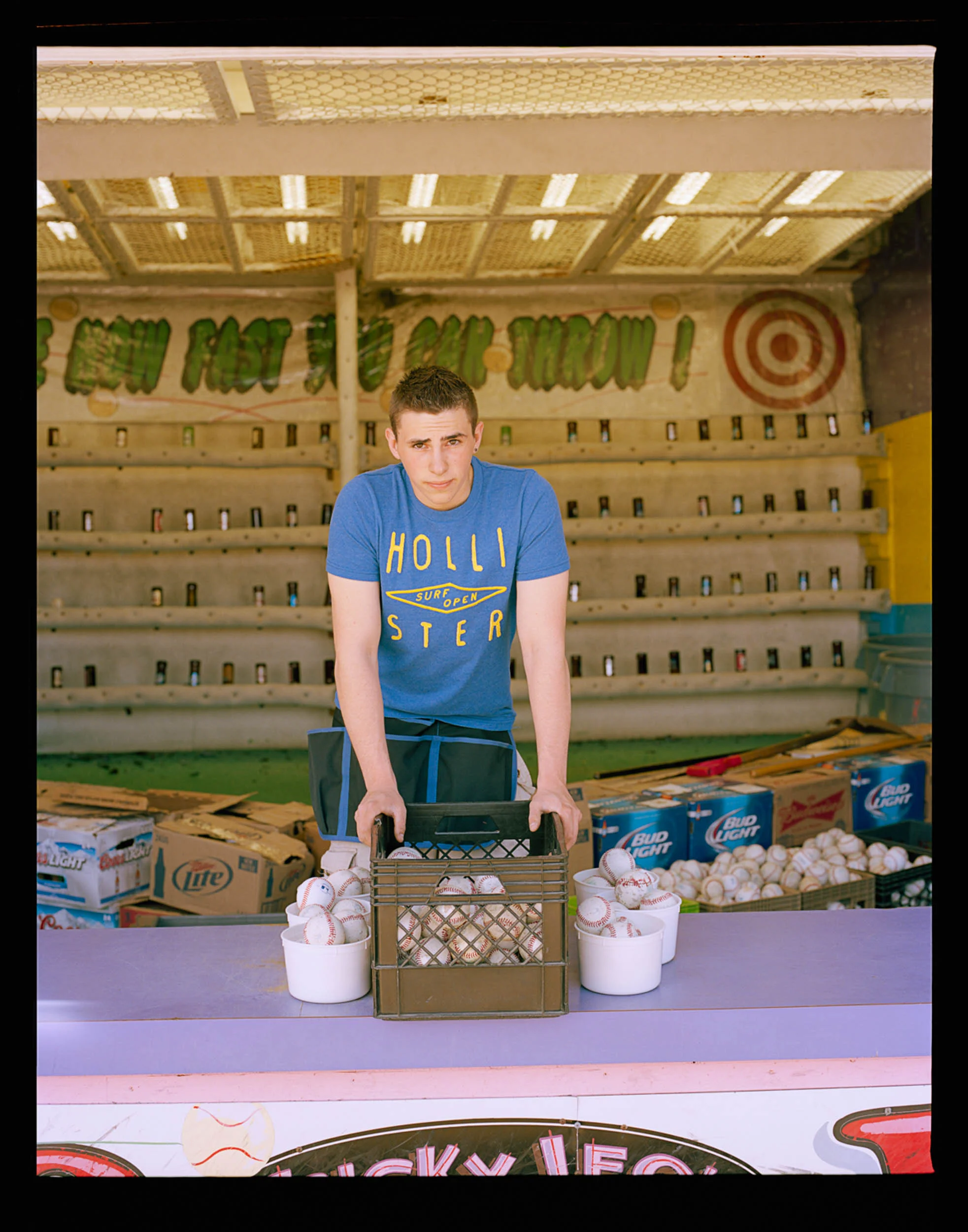 Chris, Seaside, NJ 2014 120 Mamiya RZ67. I asked Barry if he knew anyone who would let me photograph them because I felt like I did not have enough portraits of the people that make the boardwalk run. He introduced me to Chris who let me photograph him while he was running the stand where you break a bottle with a baseball. Its way harder then it looks. He asked me what to do and I told him to just put his hands on the basket of balls and look into the lens. Thanks!