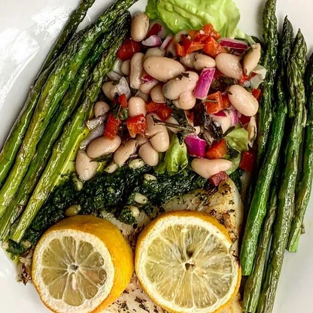 Lemon, garlic and pesto baked cod with asparagus and a fresh mint and cannelloni bean salad.