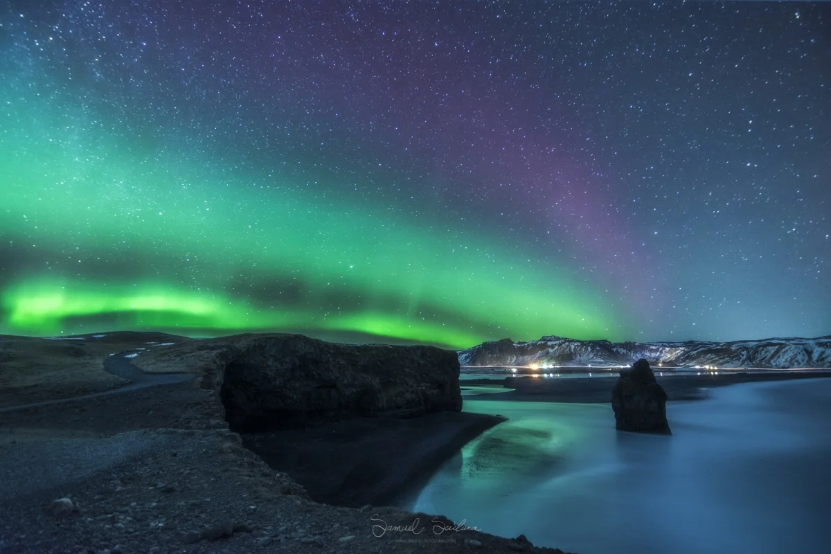KP3 Auroras dance above Arnardrangur sea stack near Dyrhólaey in Iceland.