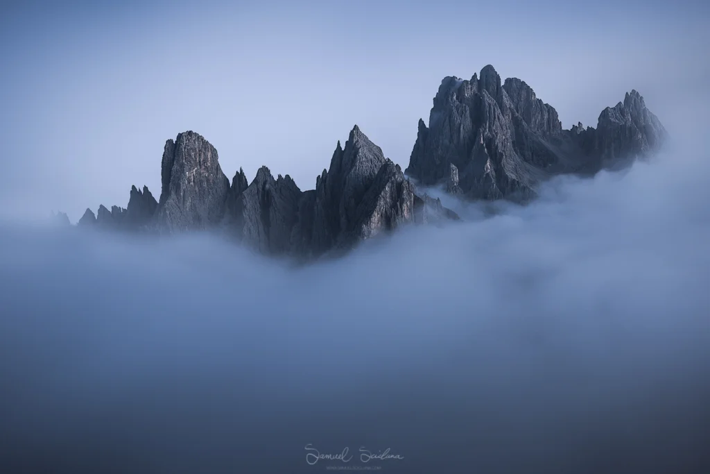 The Cadini di Misurina peaking through the low clouds.