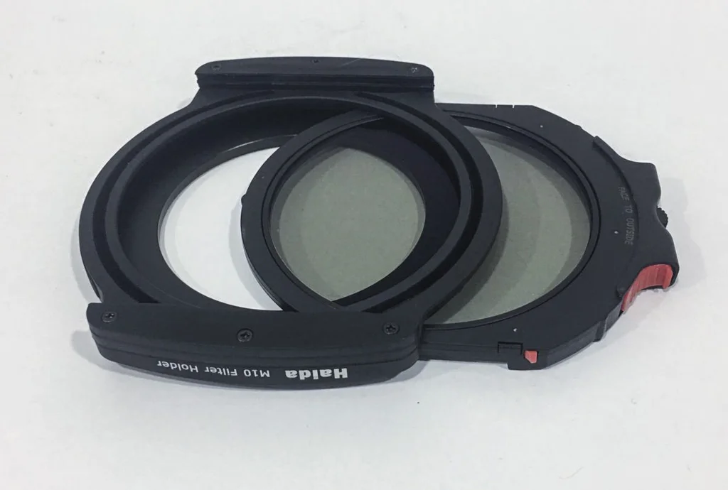 The M10 holder with the Drop In circular polarizer half-inserted.