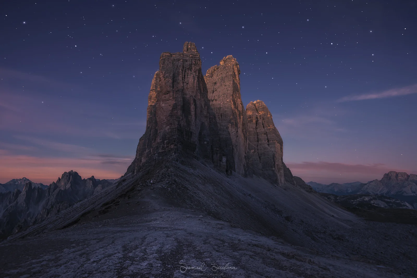 Alpen glow hitting the Tre Cime before sunrise as the stars fade into the dawn.