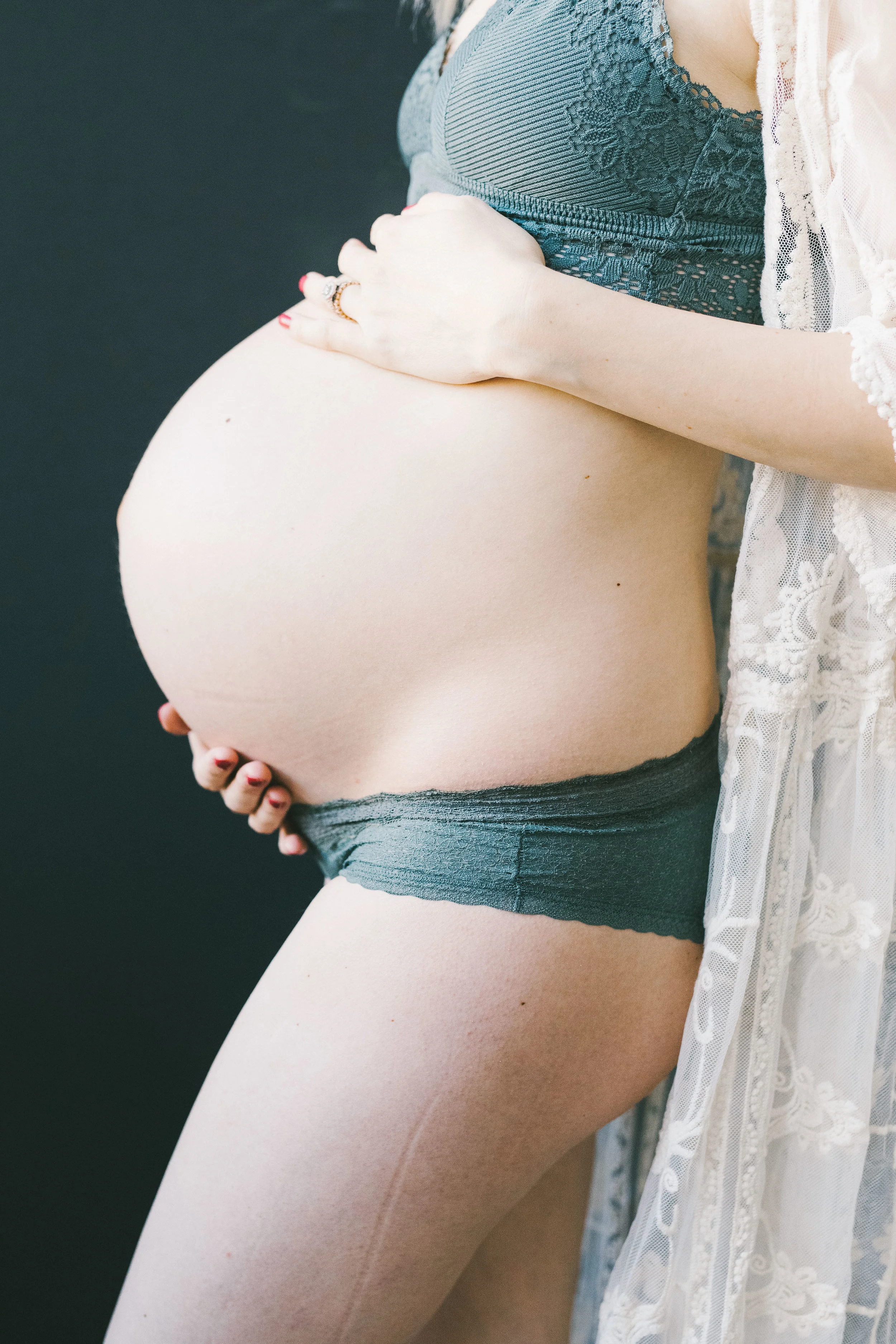 Maternity session with daughter in a light filled studio with flowers and heart by Chelsea Macor Photography-8.jpg