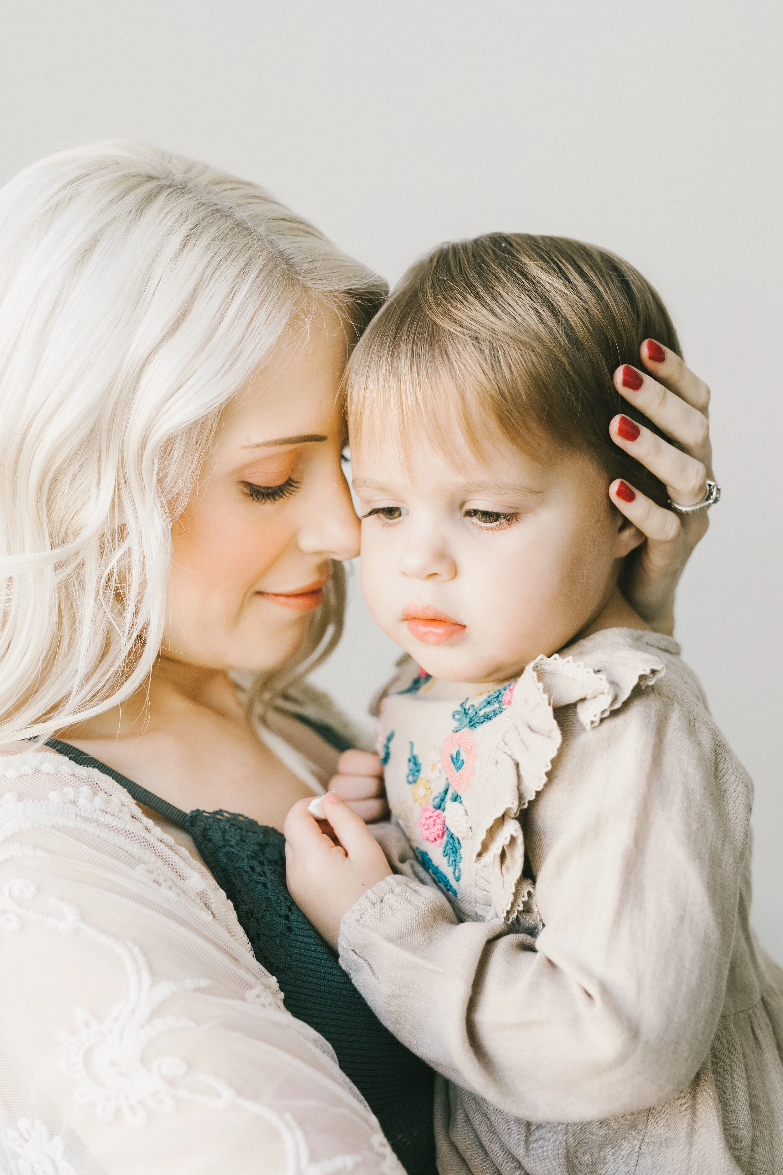 Maternity session with daughter in a light filled studio with flowers and heart by Chelsea Macor Photography-12.jpg