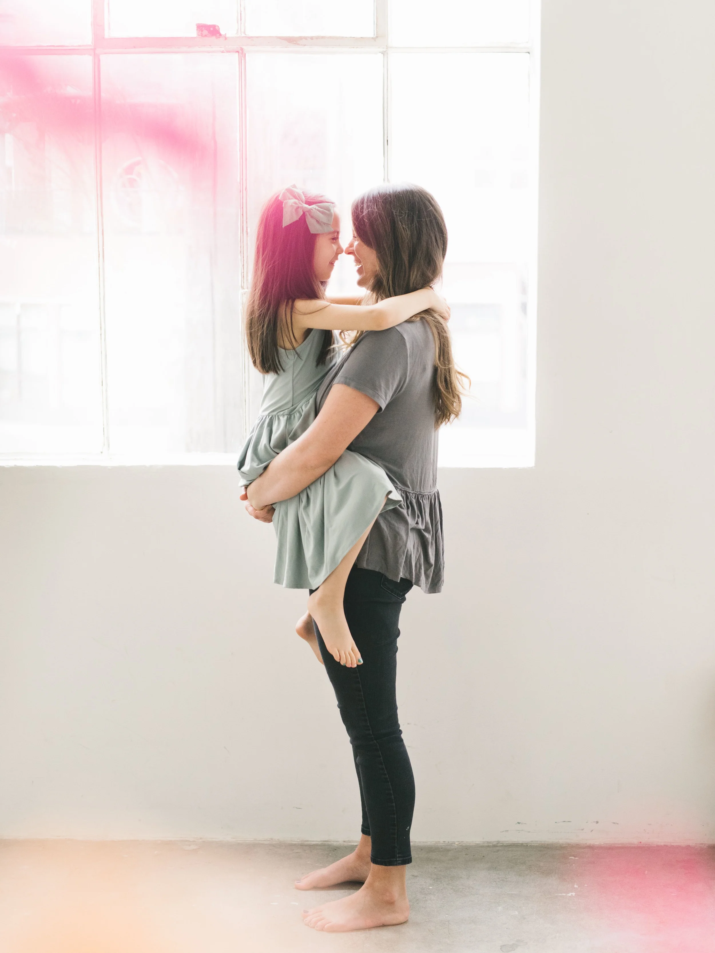 A cuddly and feminine mother daughter session in a Seattle studio with flowers by Chelsea Macor Photography