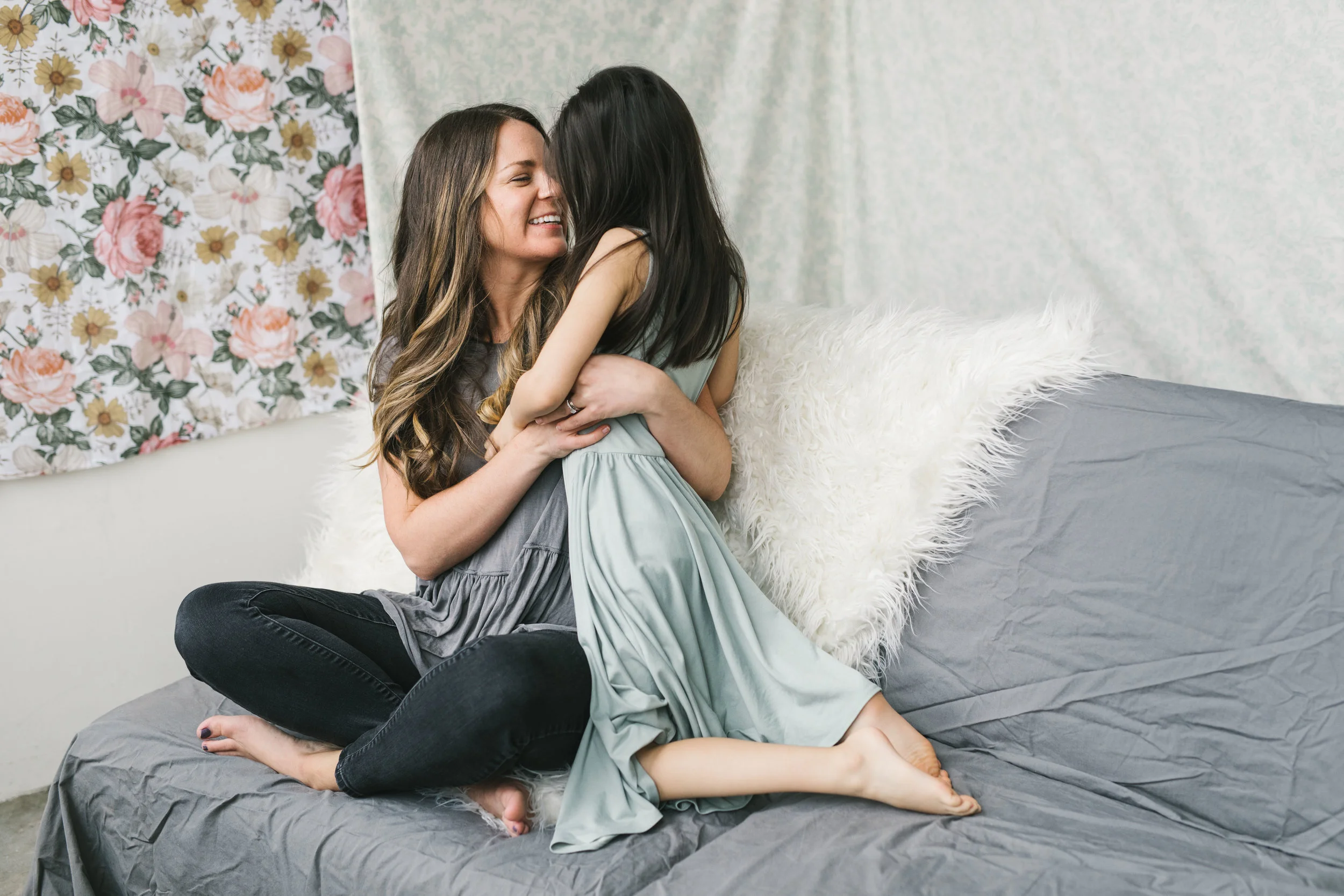 A cuddly and feminine mother daughter session in a Seattle studio with flowers by Chelsea Macor Photography