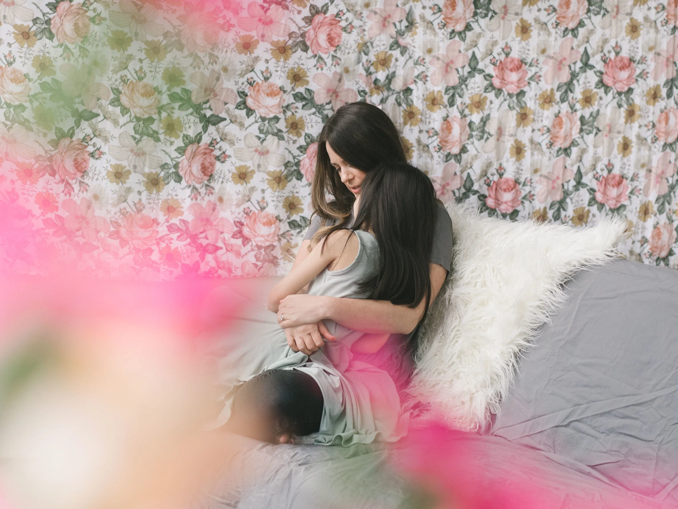 A cuddly and feminine mother daughter session in a Seattle studio with flowers by Chelsea Macor Photography
