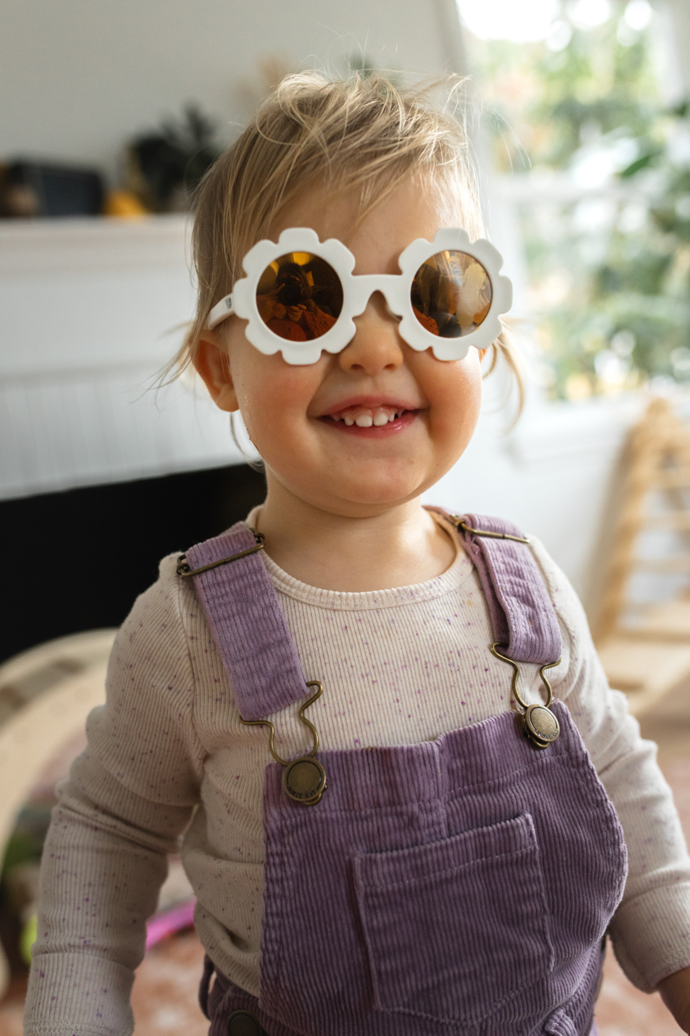 Adorable toddler in pigtails in seattle wa at home in sunglasses