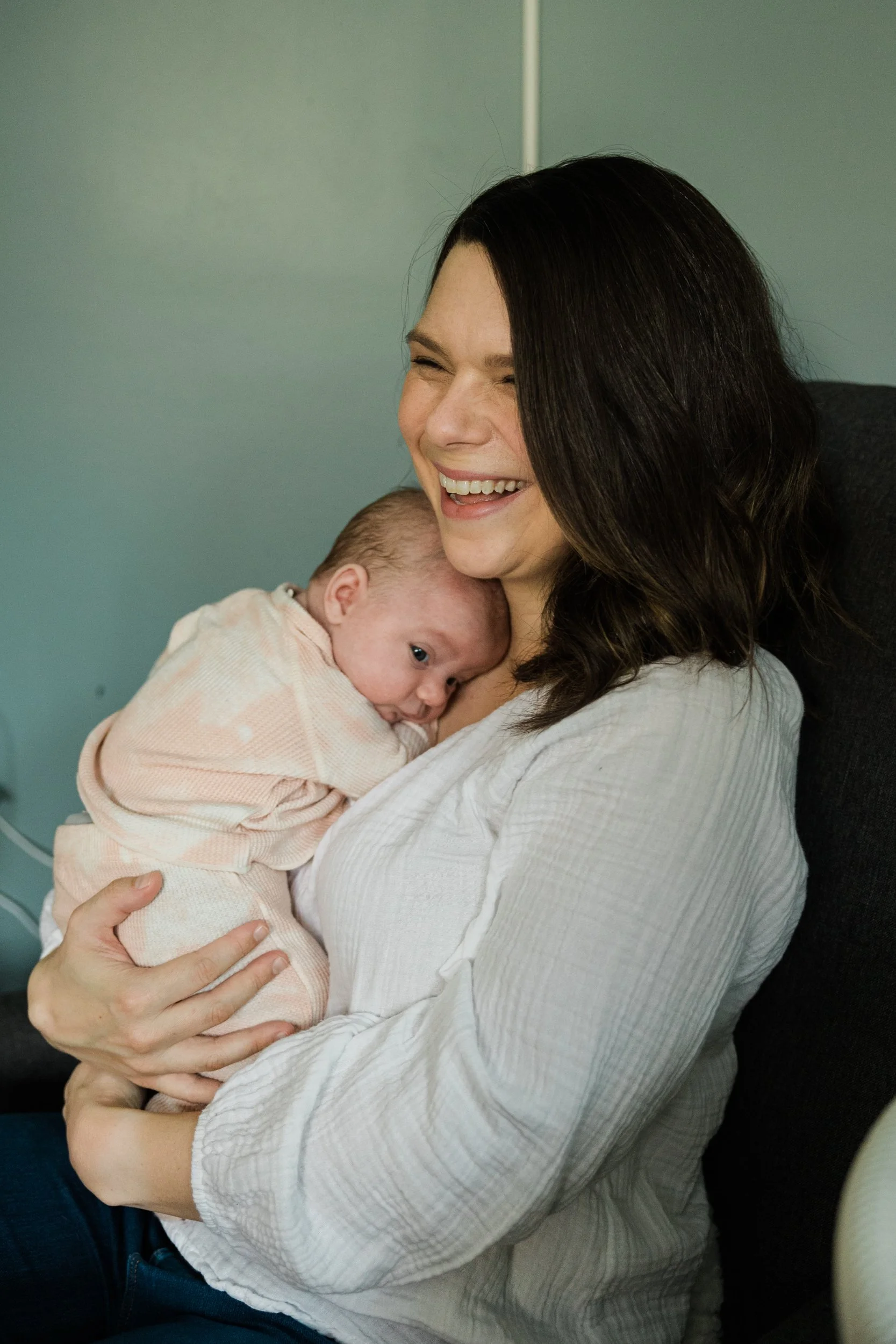 mom cuddles baby on chest
