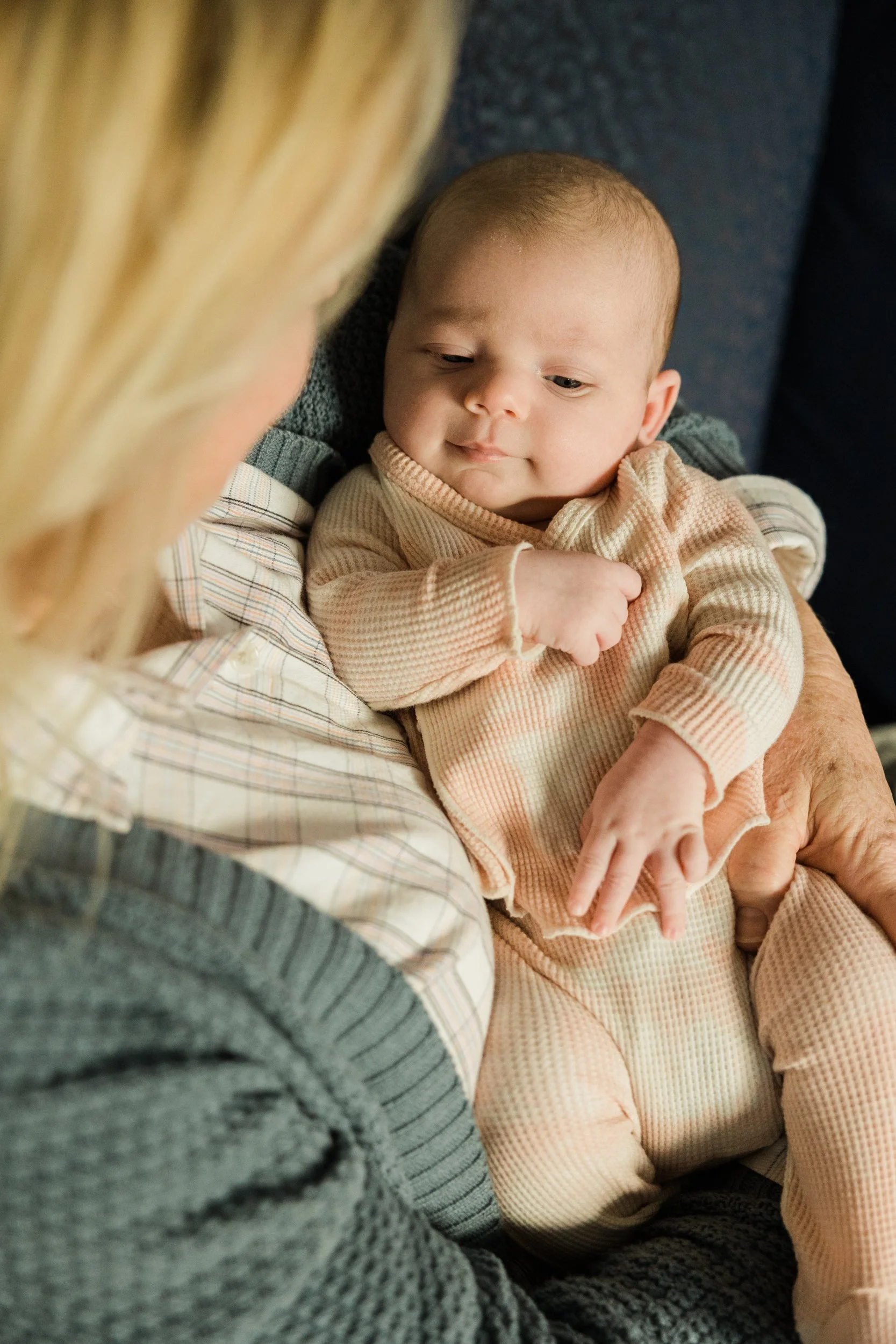 baby laying in woman's arms