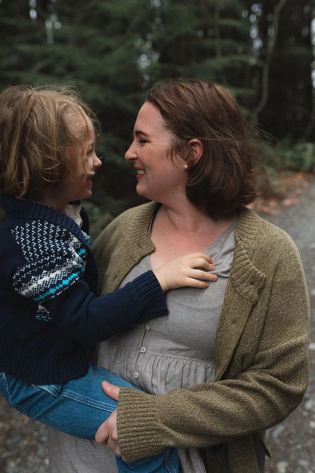 small boy and mother look at each other with a smile