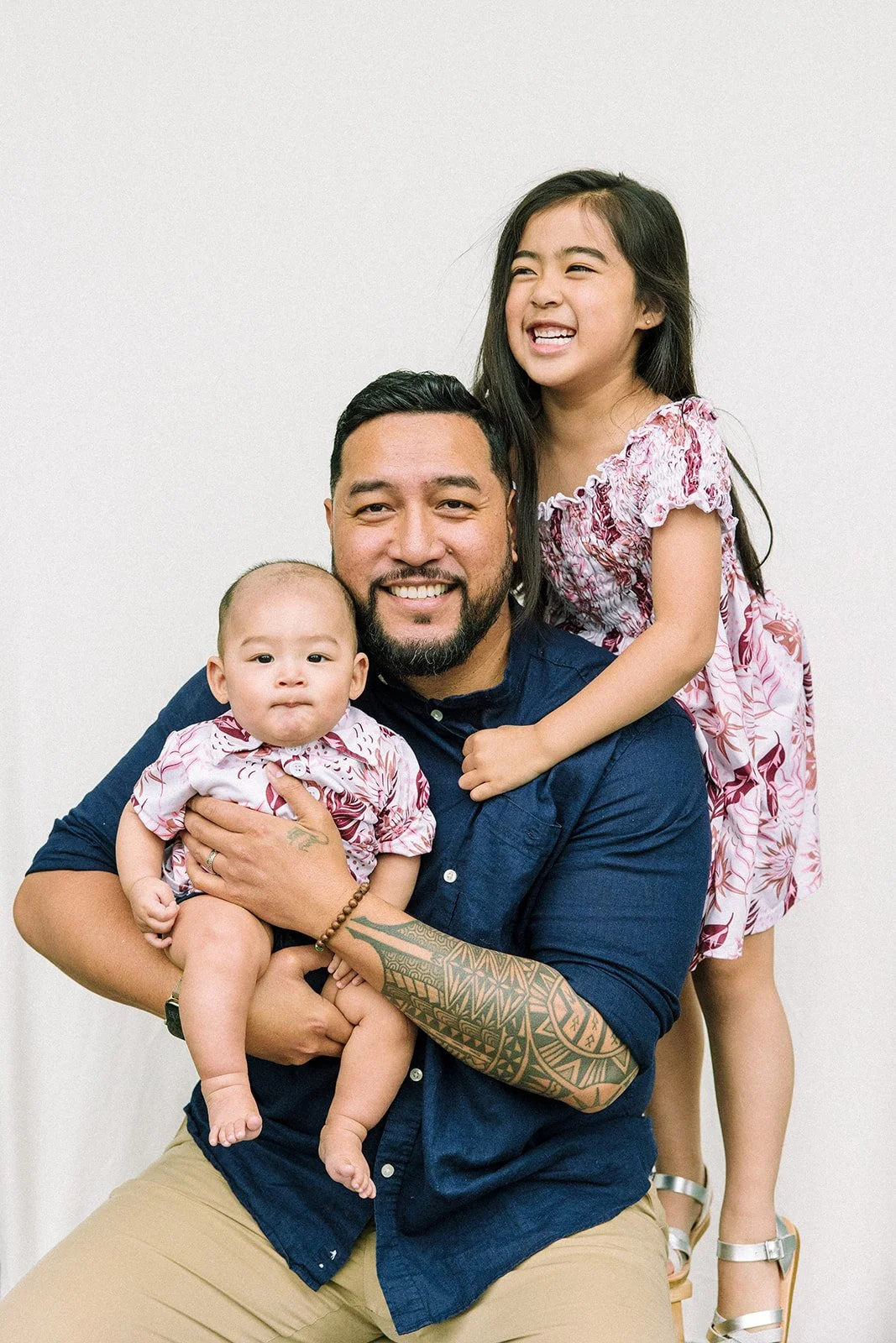Photo of a dad and his two kids hugging him for father's day at Village Maternity in Seattle by Chelsea Macor