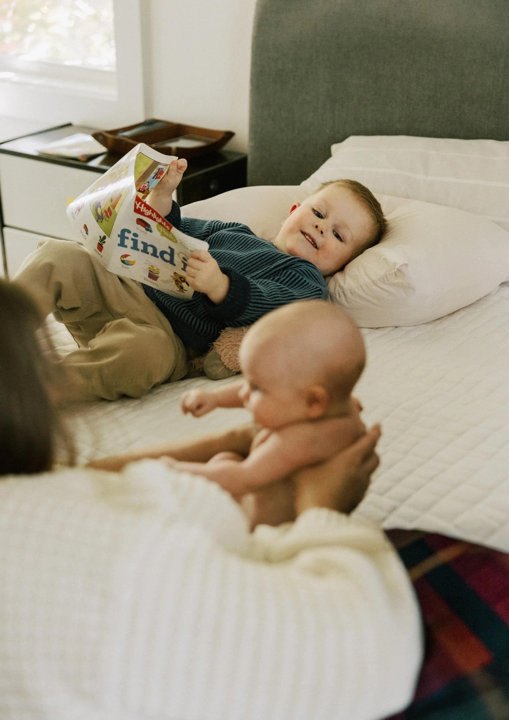 big toddler brother watches newborn sister
