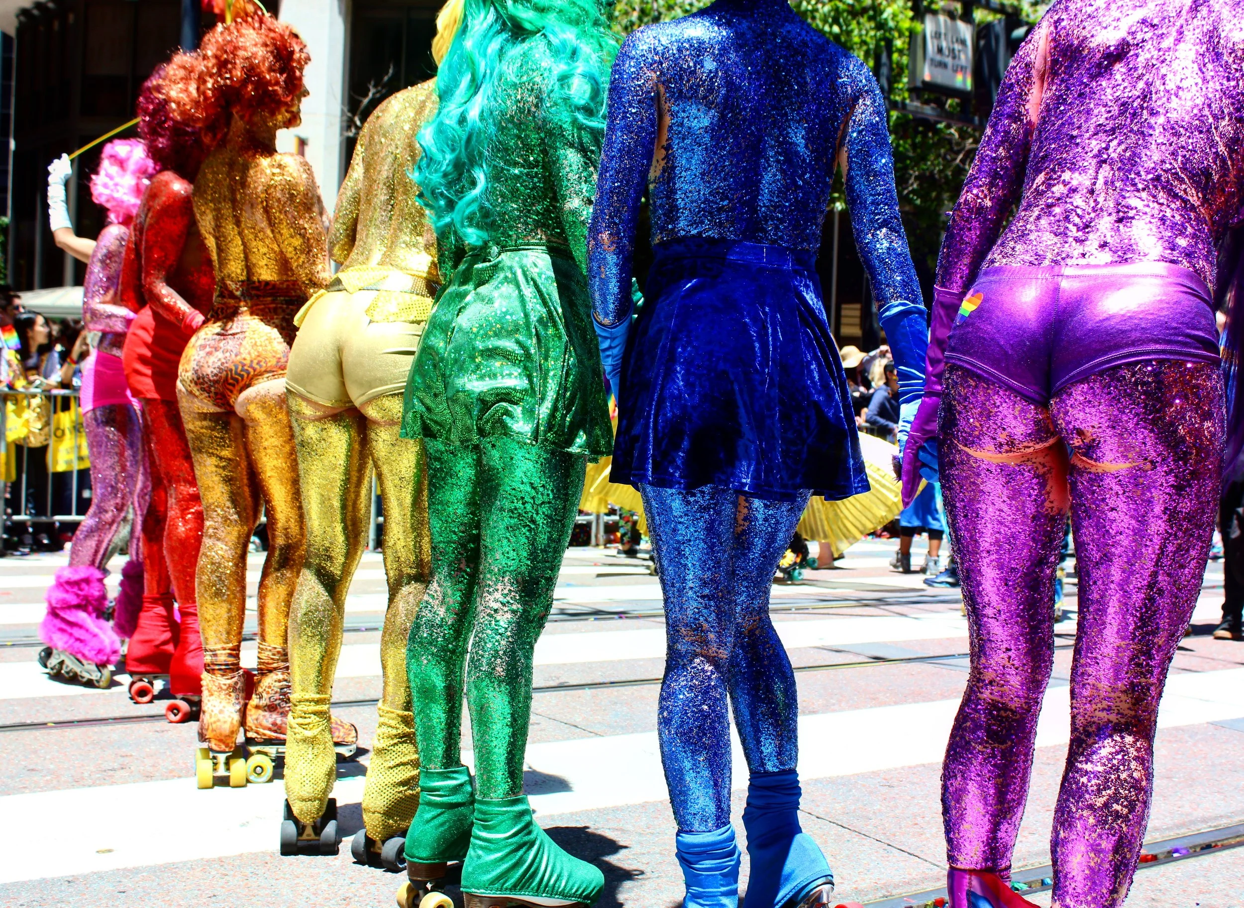 Roller skaters covered in body glitter pose during the 2017 San Francisco Pride Parade. June 2017