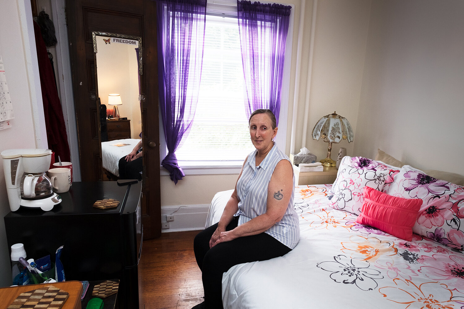  Louise, 60, in a house she shares with five other women, five years after her release. Flushing, NY, 2017. Image © Sara Bennett. 
