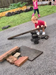 Rainy day = loose parts play! When offered a blank canvas (empty parking lot and no toys), their creative minds thrive! 