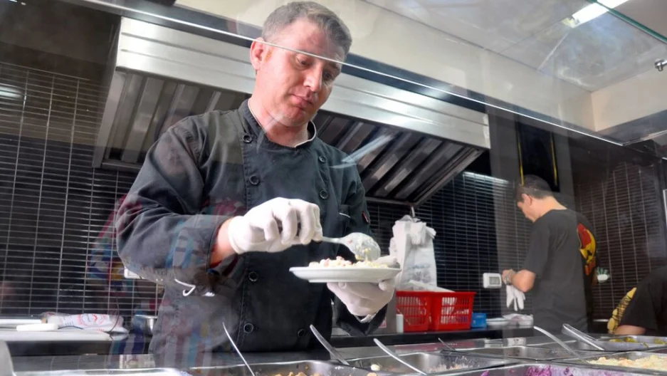Chef Wareef Hameedo prepares a plate of beans and chicken shawarma in his restaurant in Gaza. (Photo by Lauren Bohn)