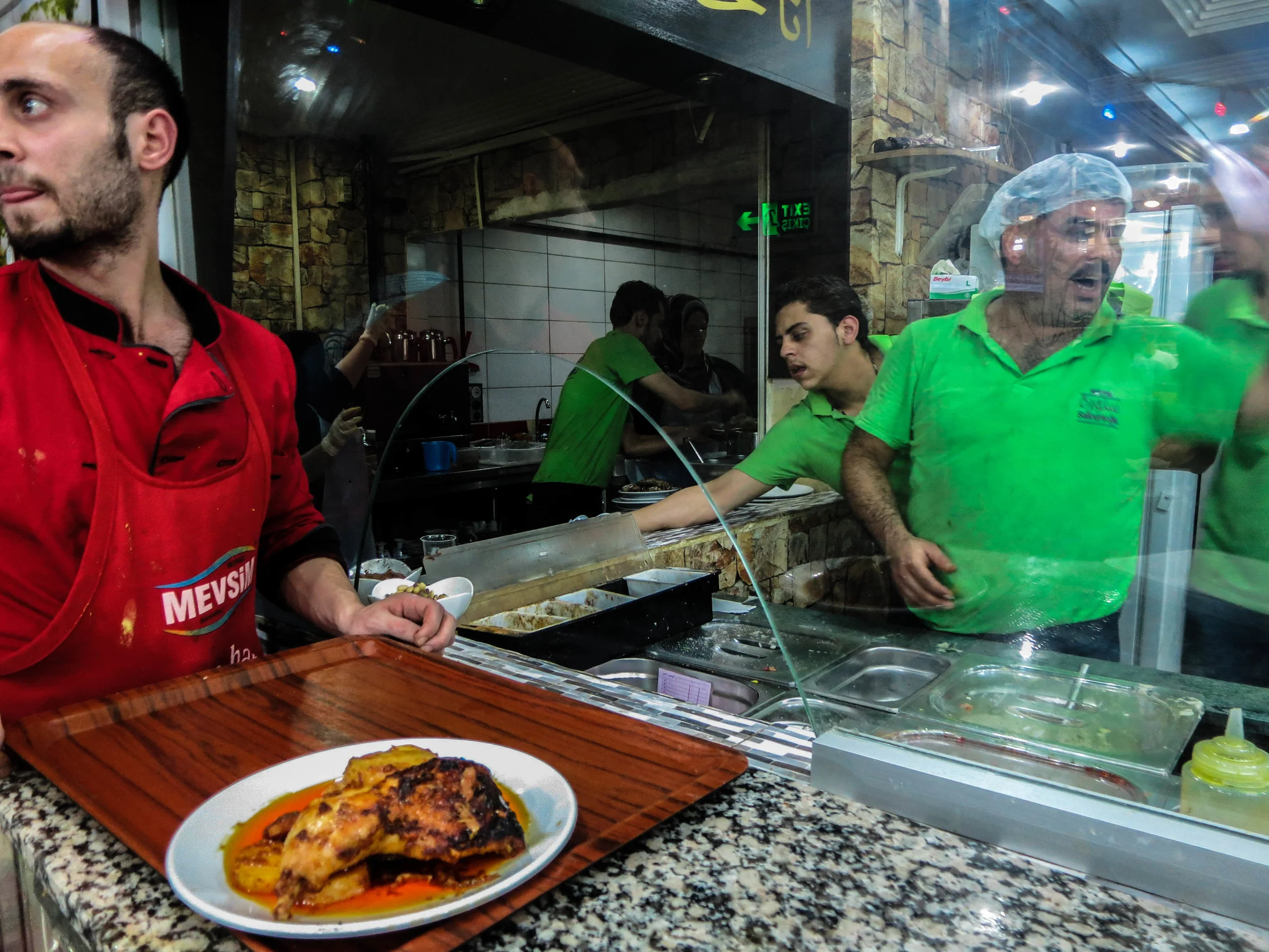 Ahmed Sheikho manages Salloura in Istanbul during the evening rush, calling out order from behind the counter. (Photo by Dalia Mortada)