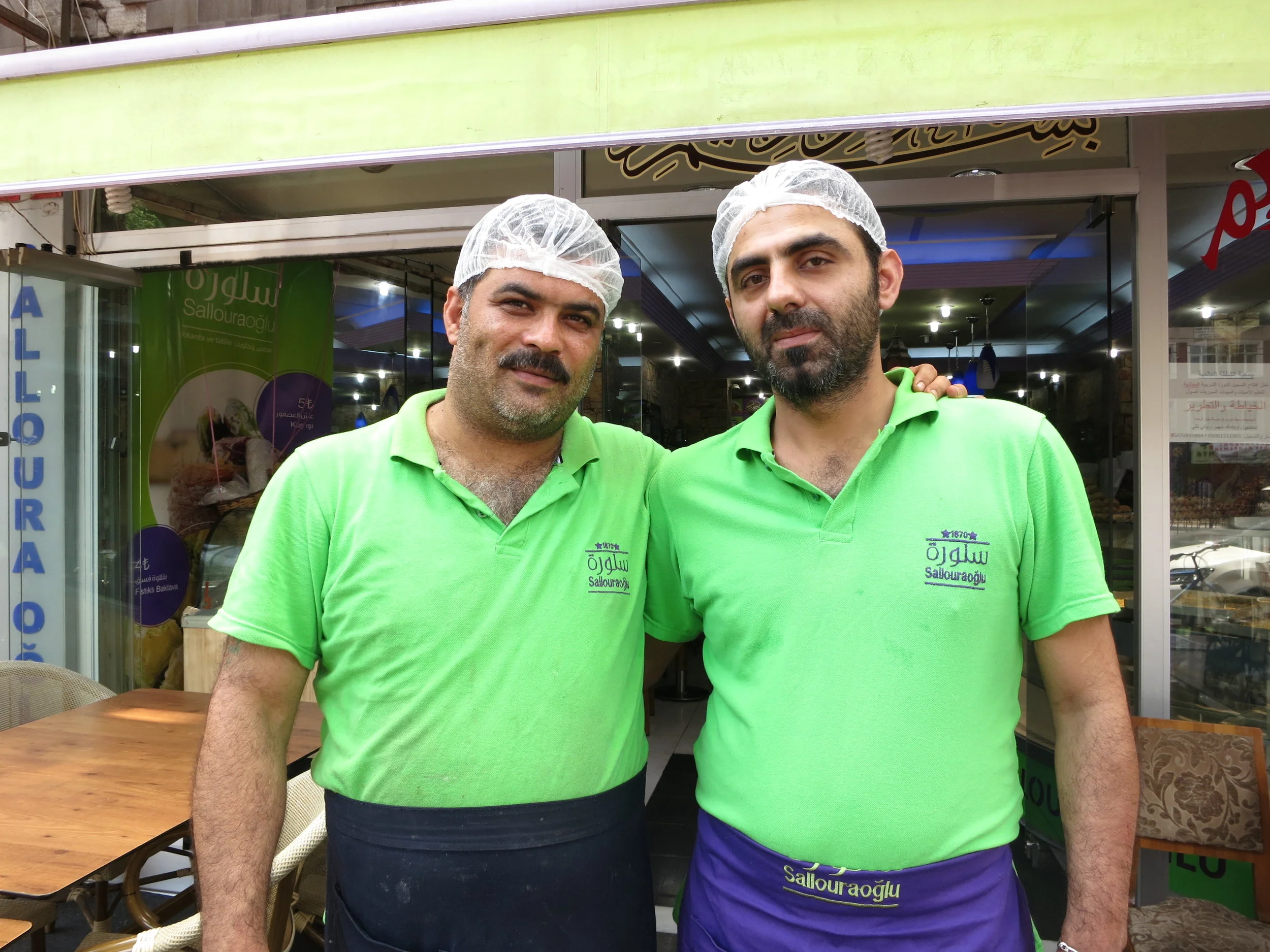 Best friends Ahmed and Rashed stand outside the Salloura shop in Istanbul before the evening rush. (Photo by Dalia Mortada)