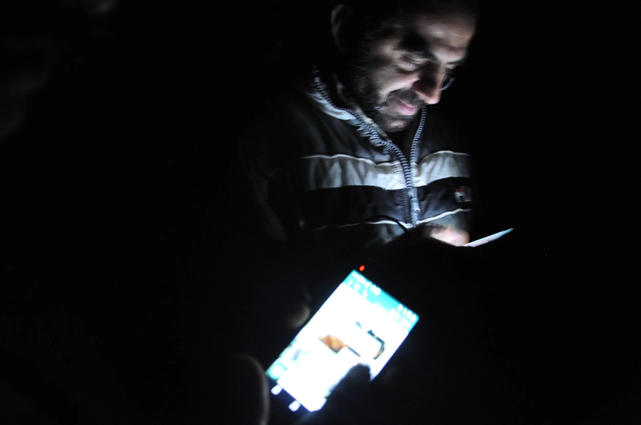 Rashed and Ahmed roam the forest in rural Germany searching for a signal to call their families. (Photo by Lauren Bohn)