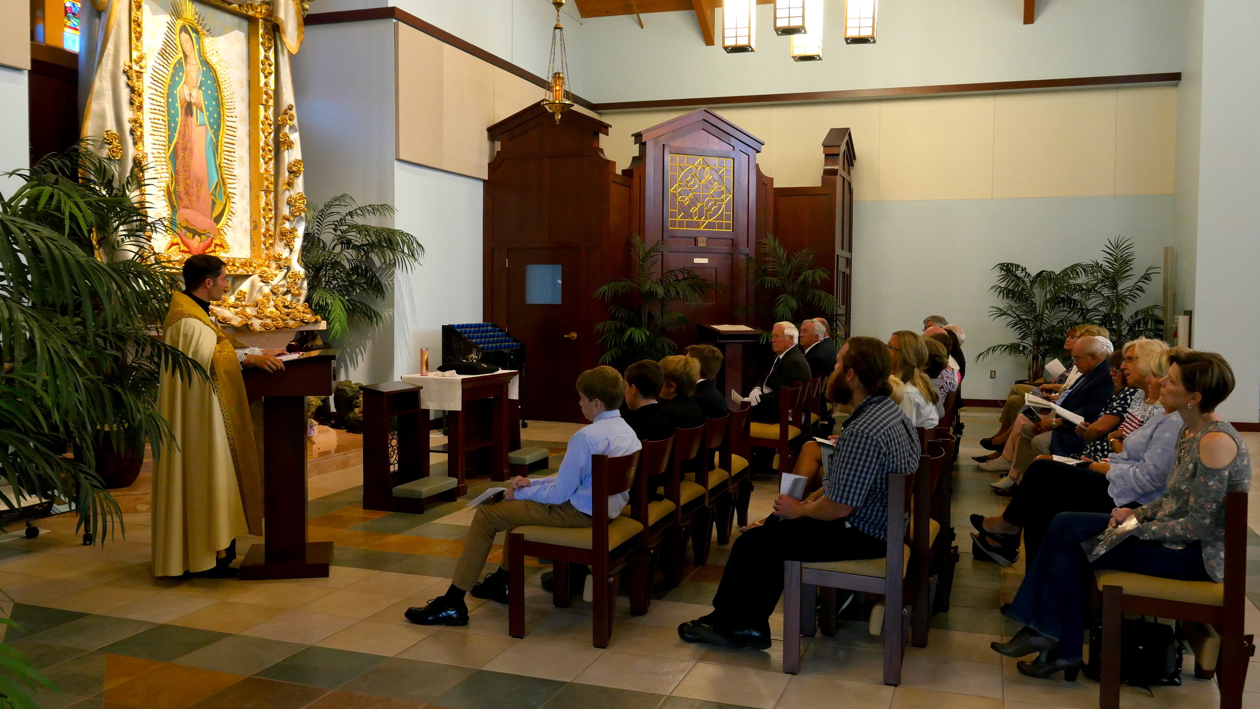 Deacon Alesandro Girardini giving homily silver rose.JPG