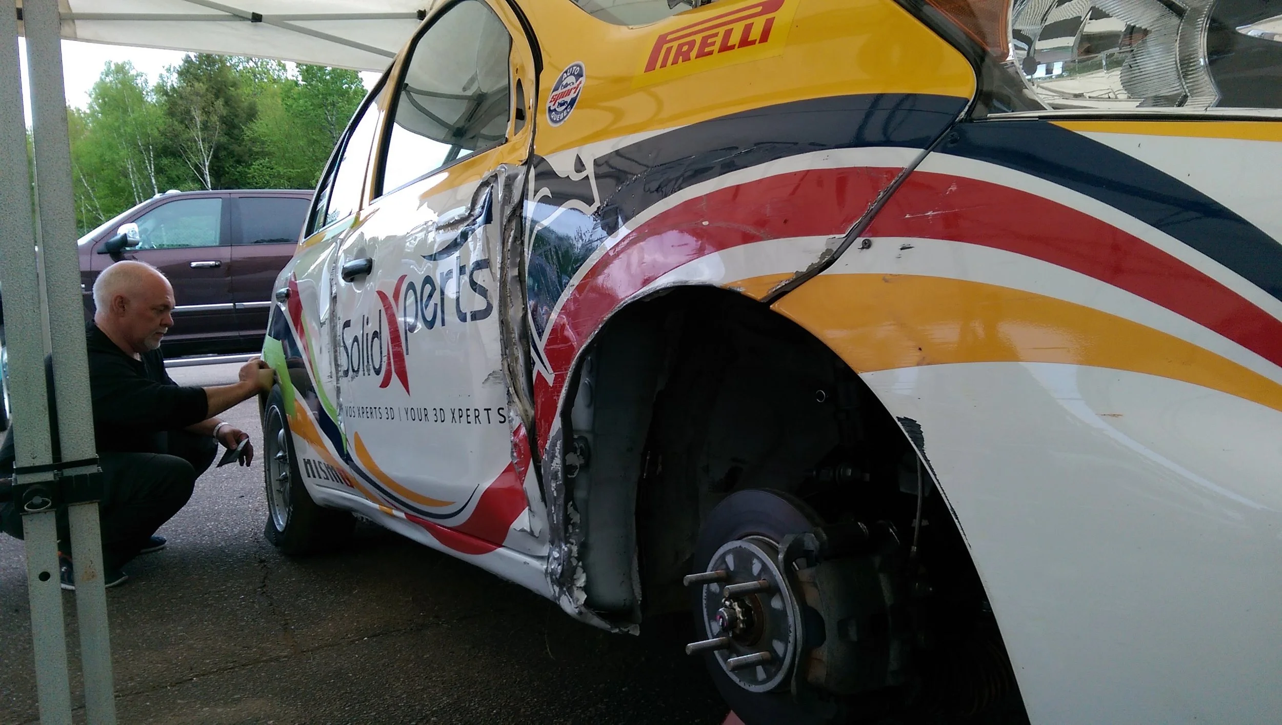 It was a matter of "All hands on deck" getting my car fixed to be able to race on Saturday and Sunday. Team owner Alex here patching up my bodywork.