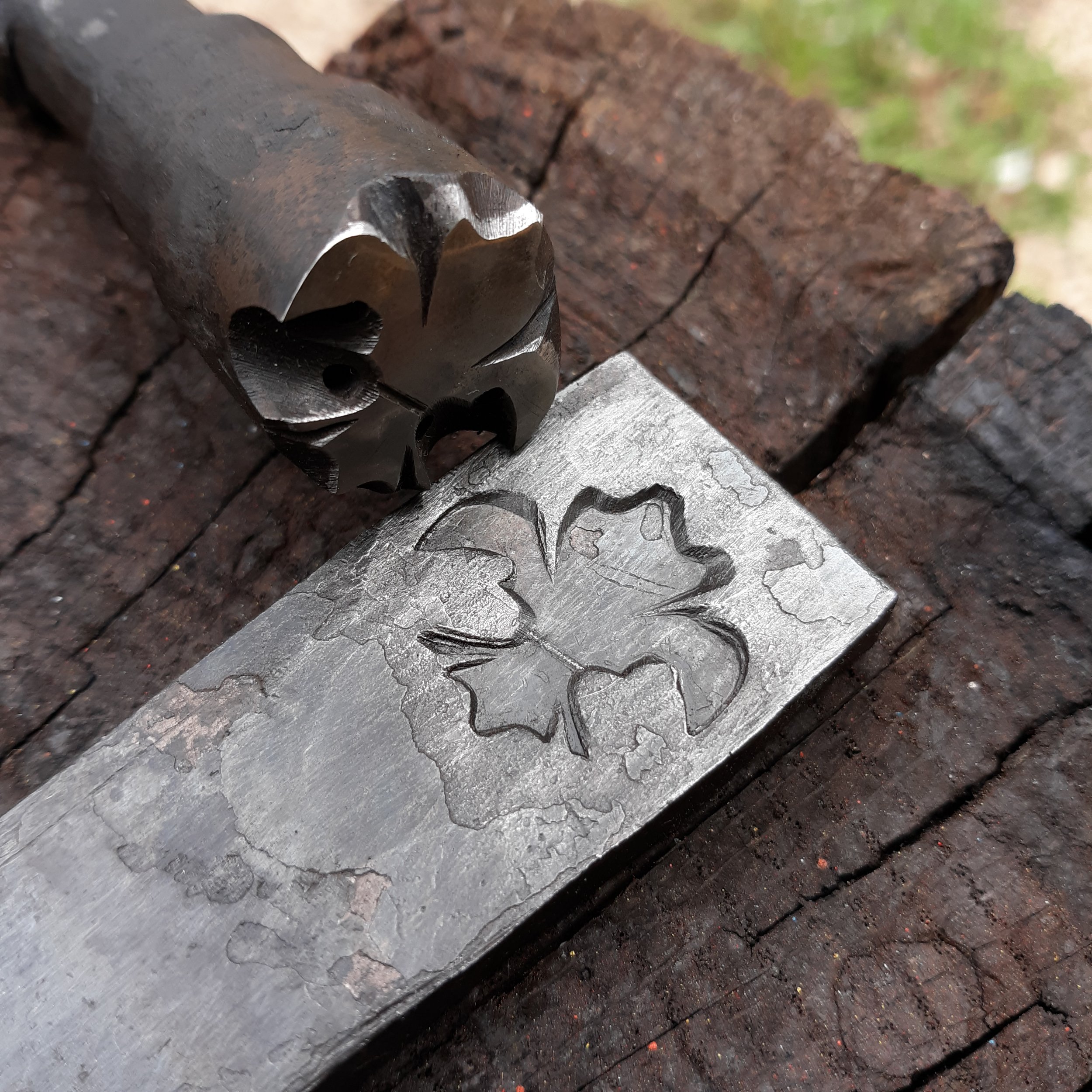 Fleur de Lis touchmark applied to a piece of metal