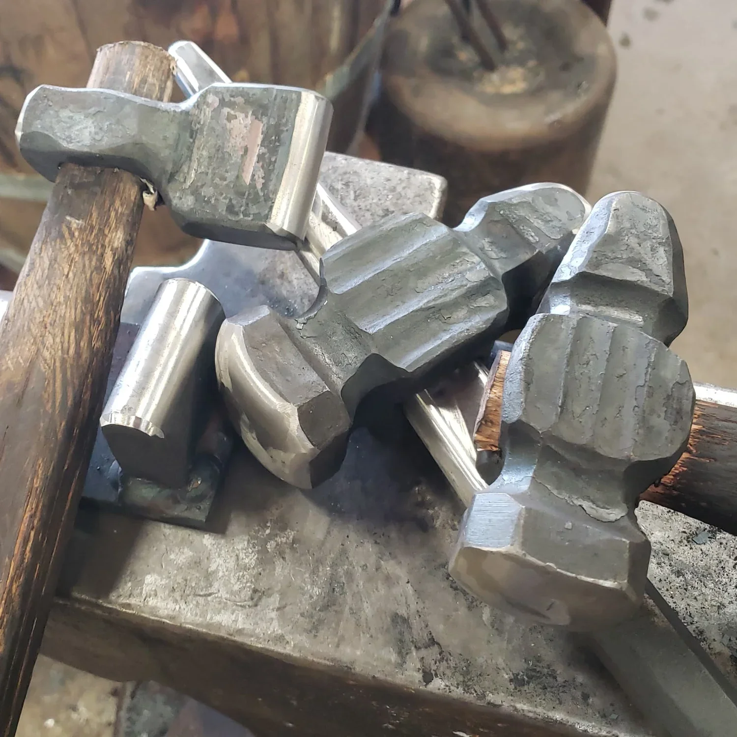 Close-up of a metal gear mechanism with interlocking teeth placed on a workbench.