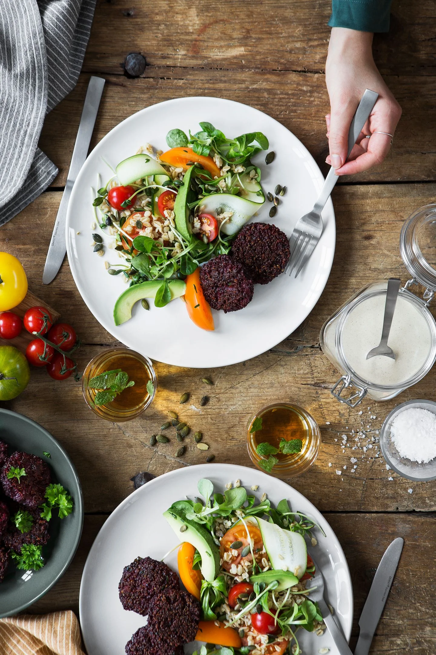 Beetroot and quinoa patties with spring oat salad and tahini dressing