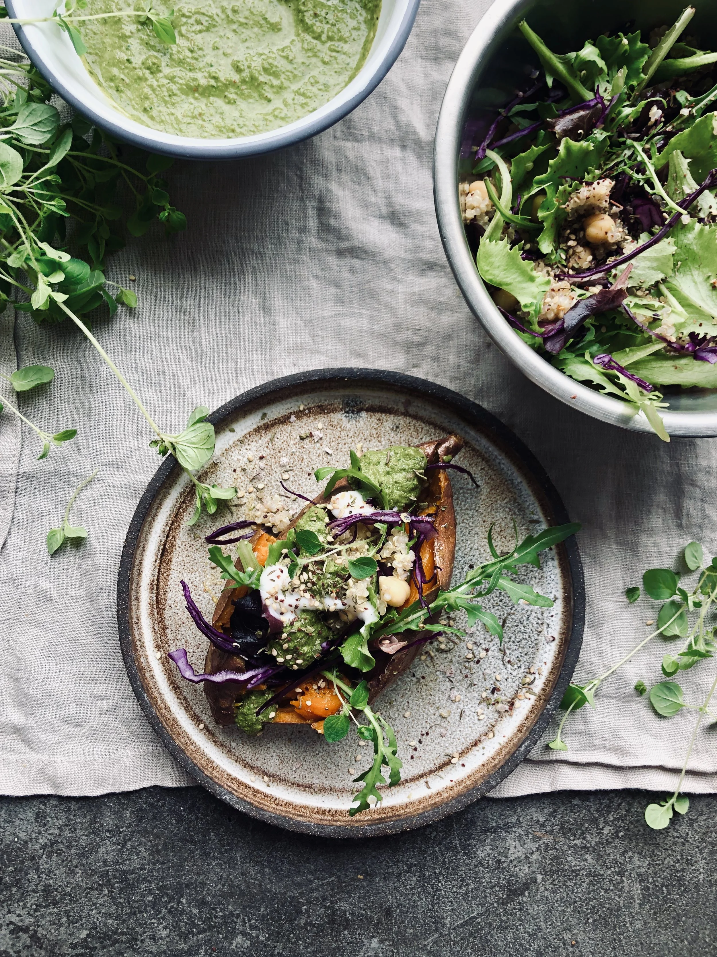 Baked sweet potato with quinoa chickpea salad and kale dressing