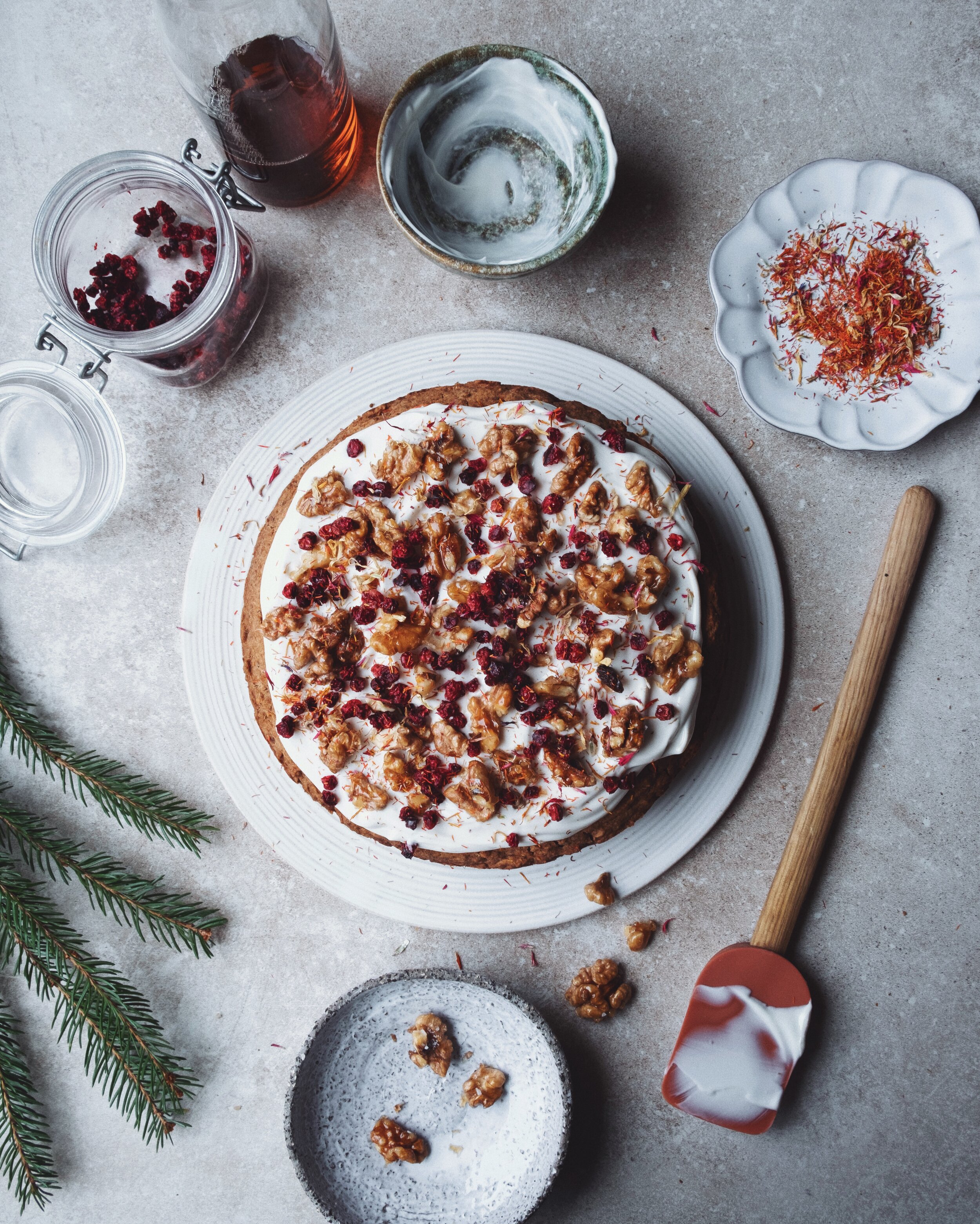 Ginger bread parsnip cake with yoghurt frosting, candied walnuts and dried lingonberries