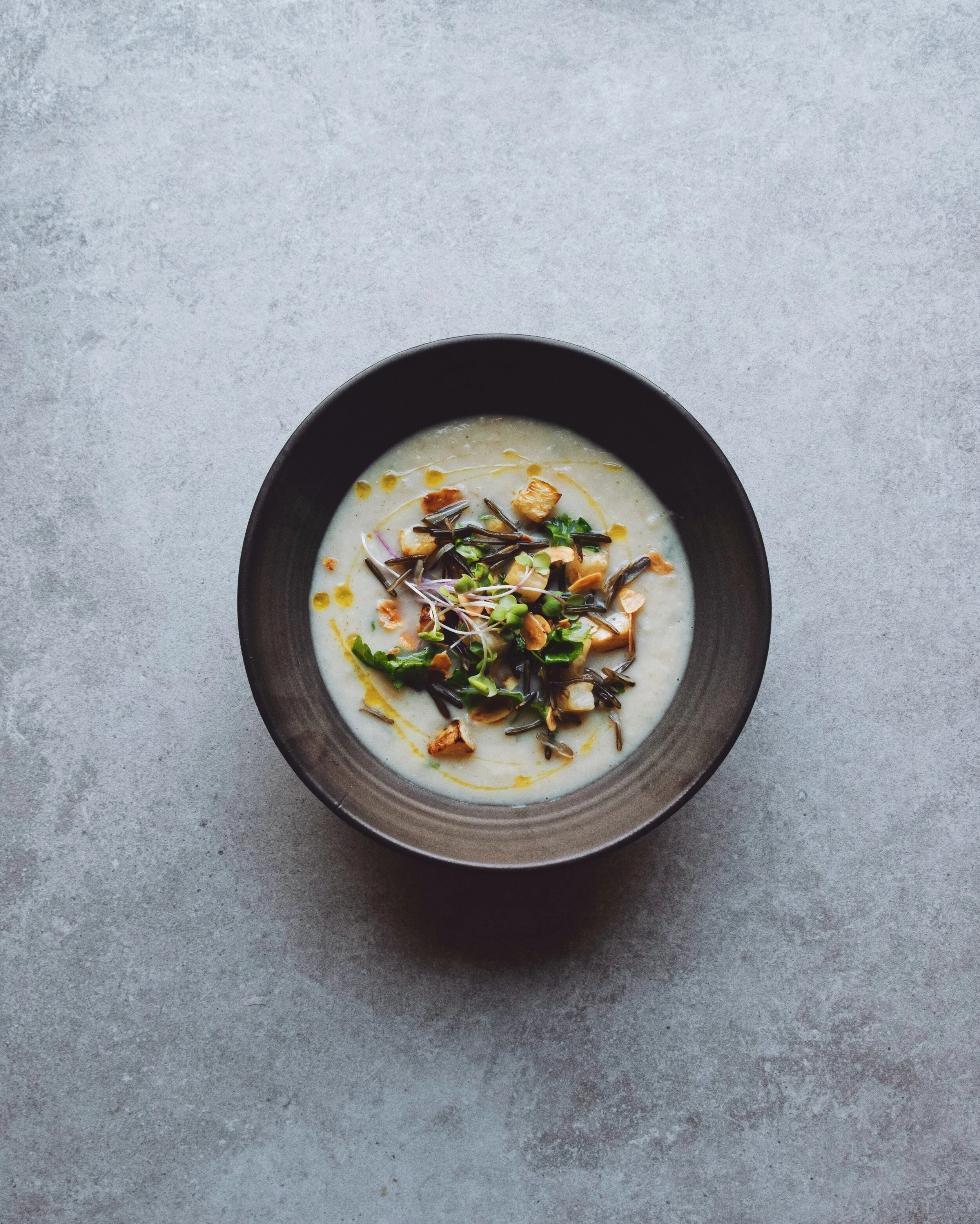 Creamy celeriac and parsnip soup with almond and parsley