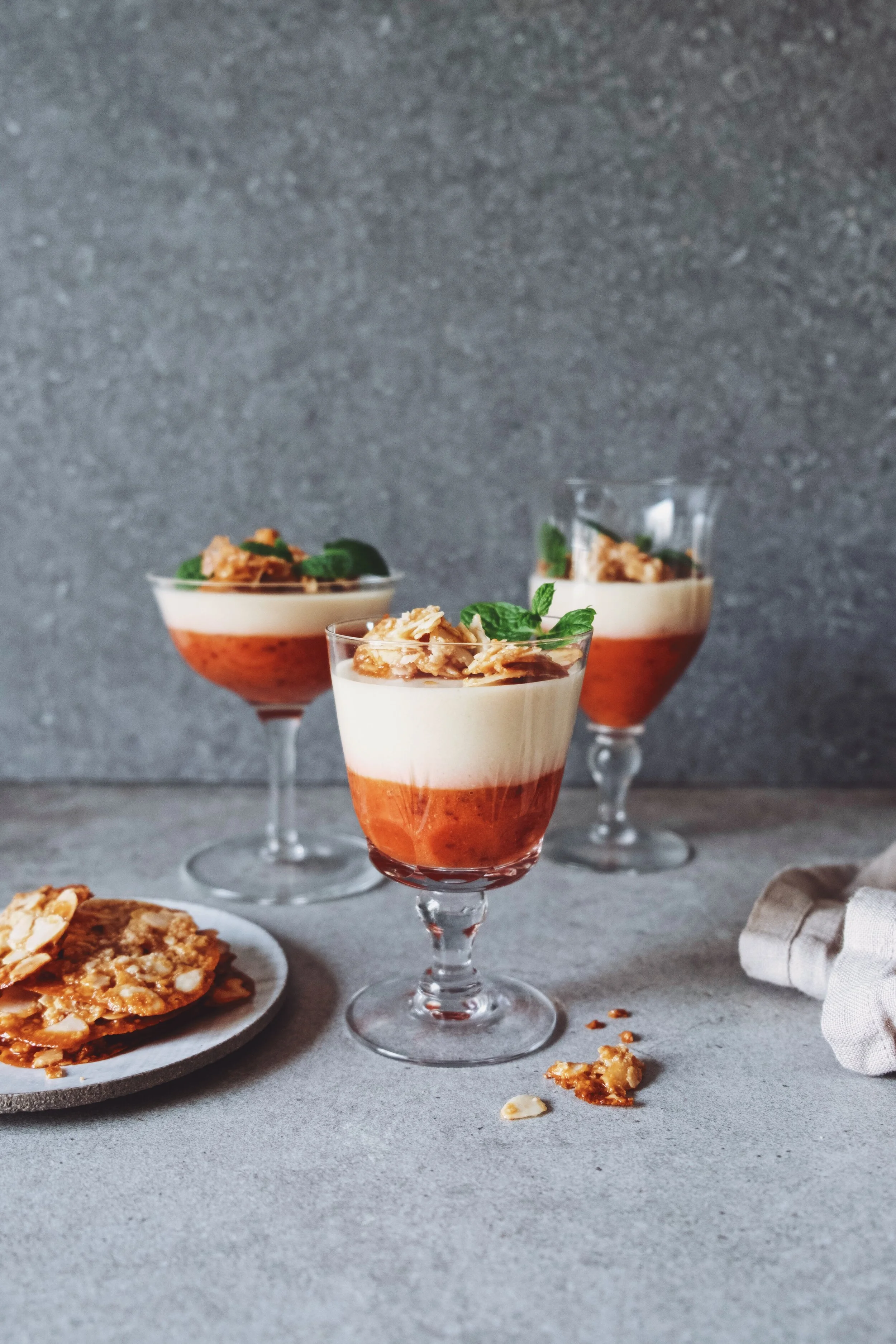 Coconut panna cotta with strawberry and sea buckthorn compote topped with almond brittle