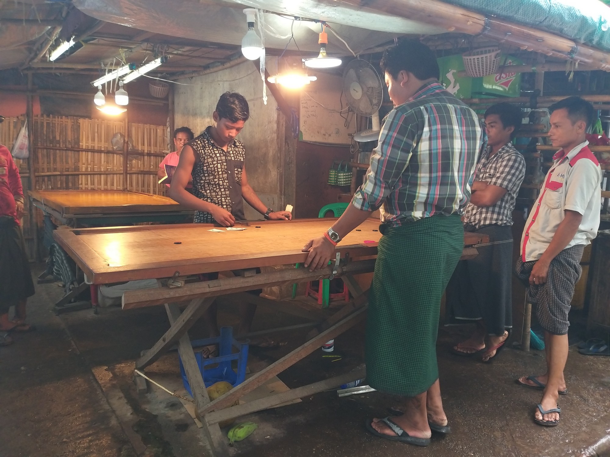 Inbetween shifts market workers chill playing carrom